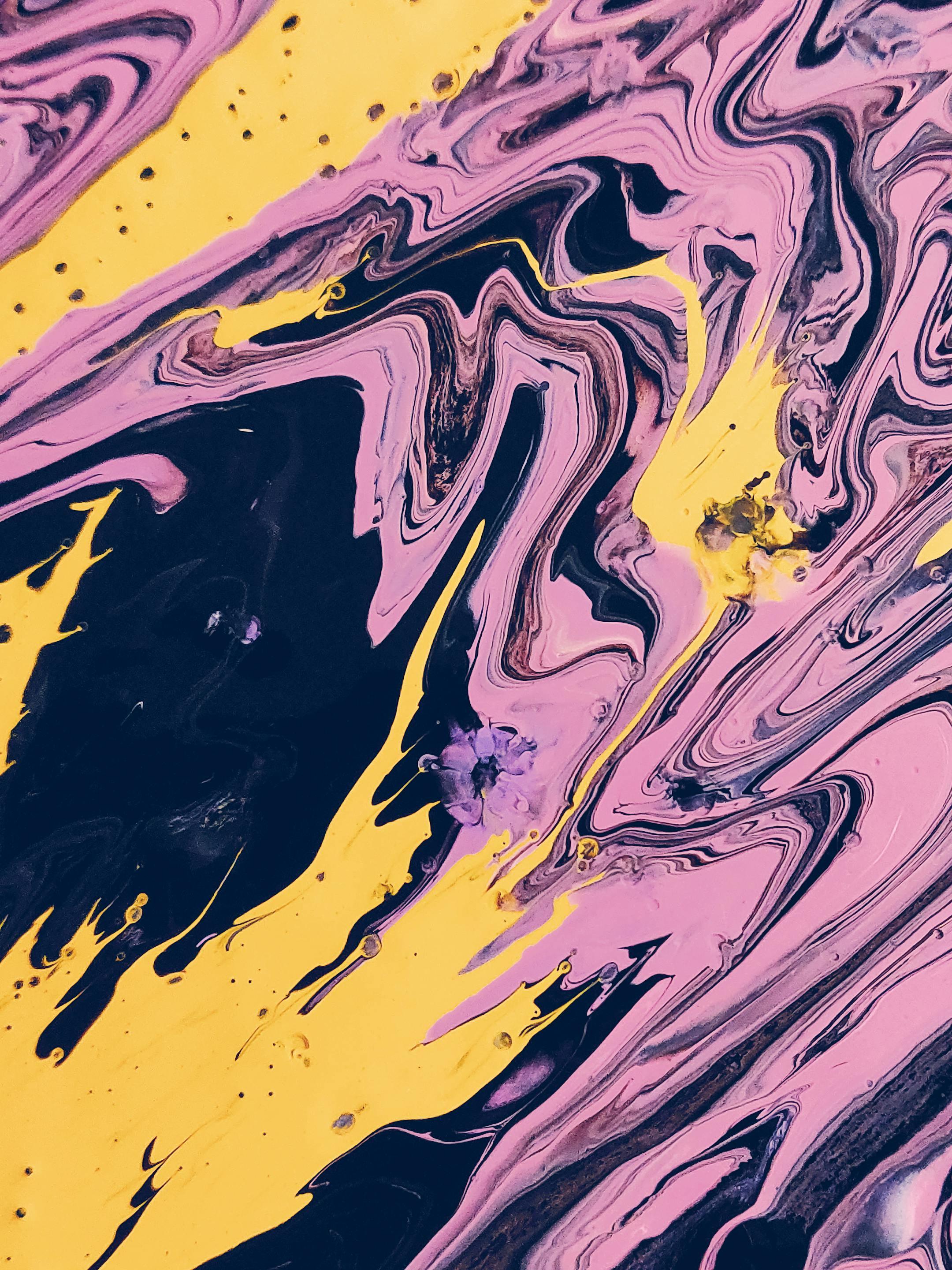 Vibrant abstract art featuring dynamic swirls of pink, yellow, and black hues.