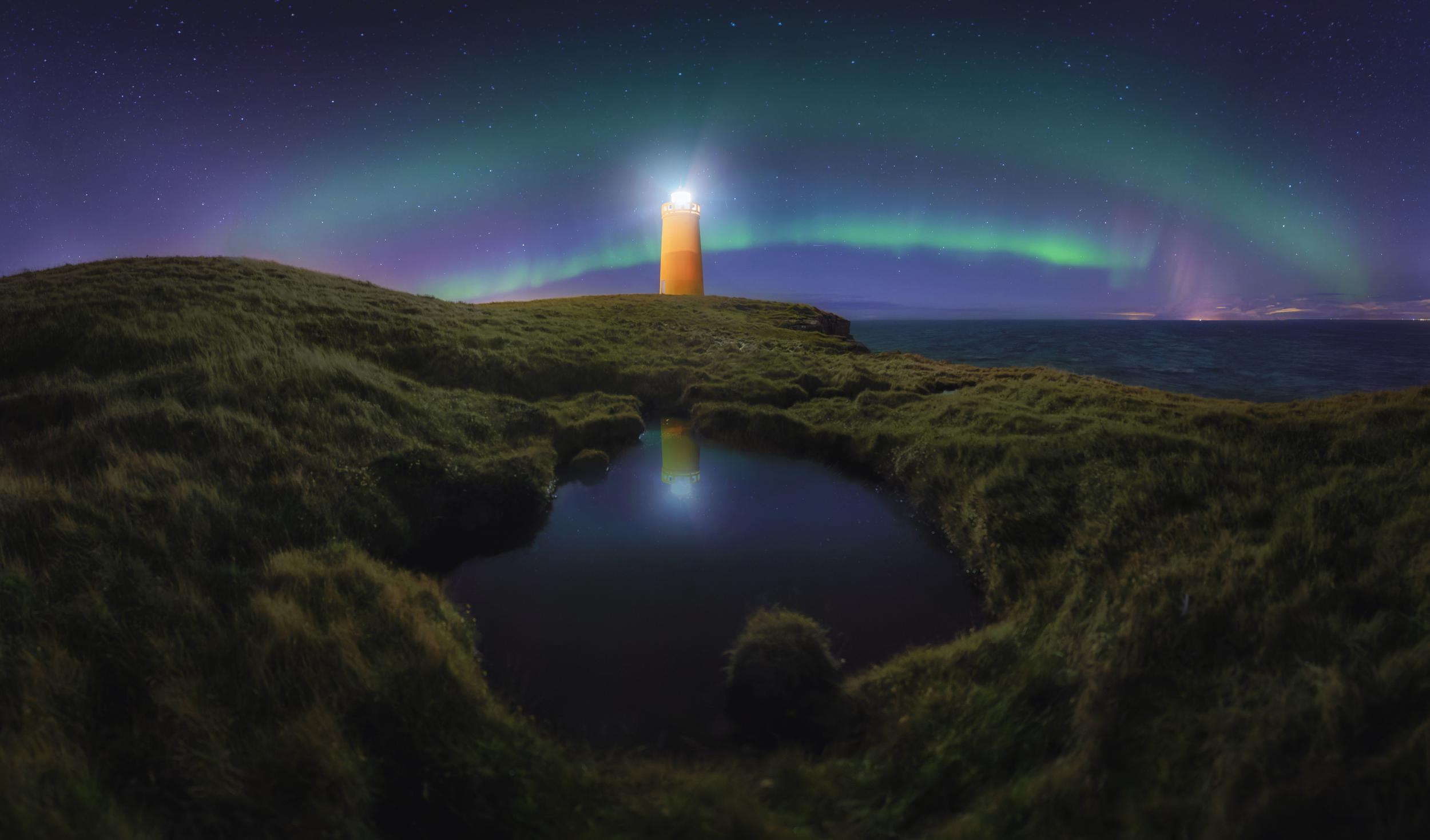 lighthouse-under-a-starry-sky-with-aurora-and-refl-2025-02-09-20-16-08-utc.jpg