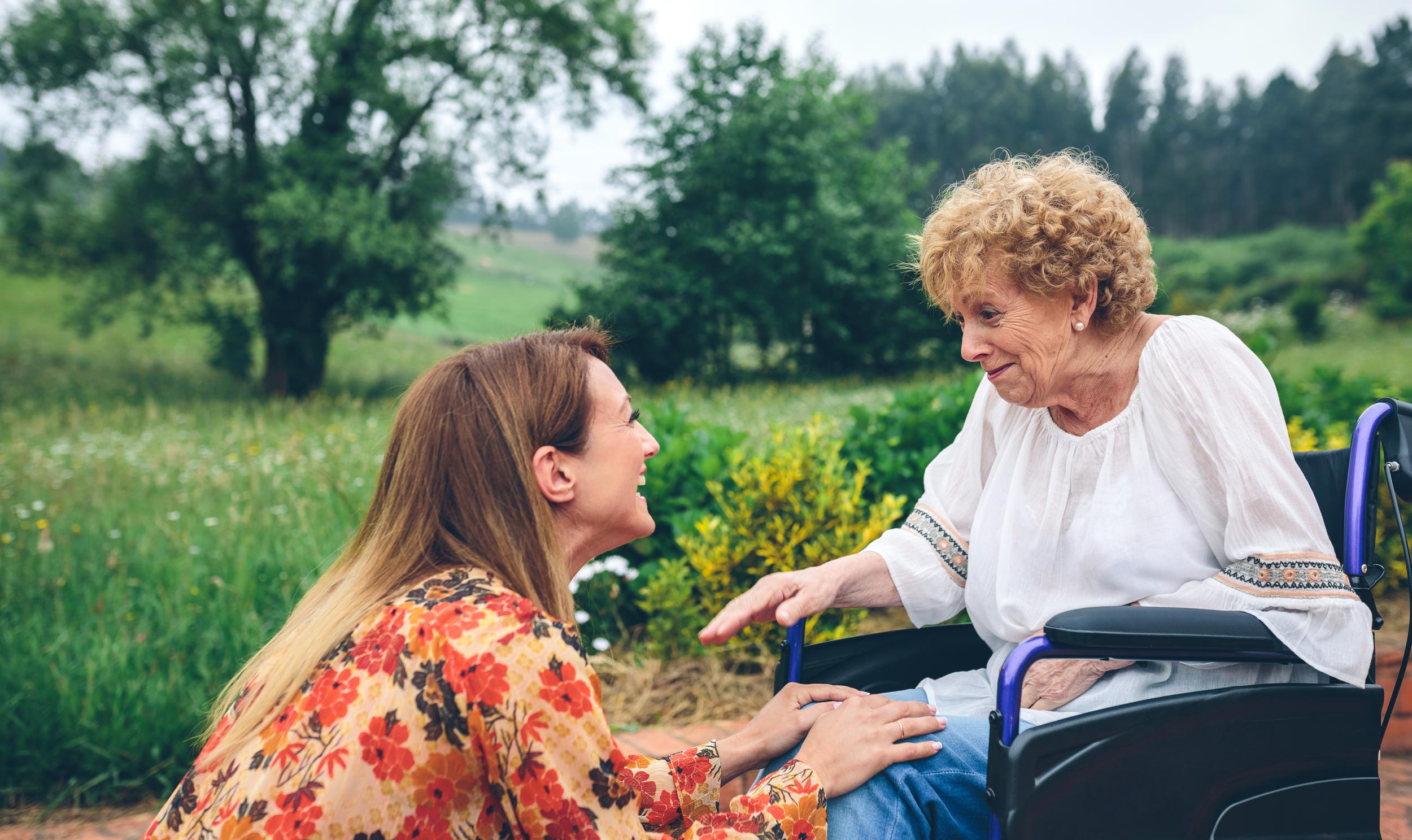 young-woman-talking-to-elderly-woman-in-a-wheelcha-2023-11-27-05-12-27-utc.jpg