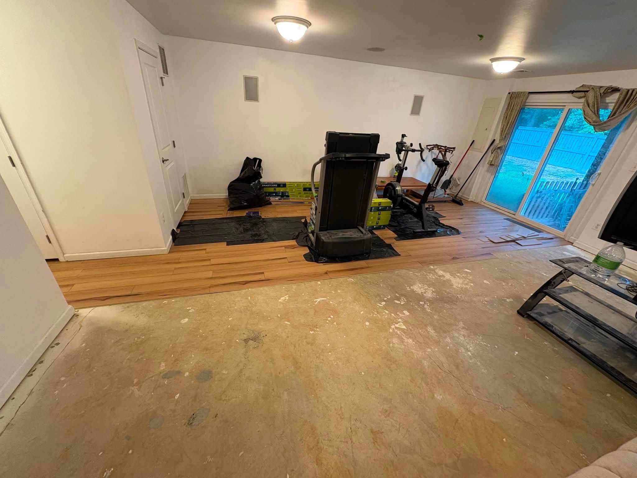 Interior flooring renovation in progress with new subfloor laid