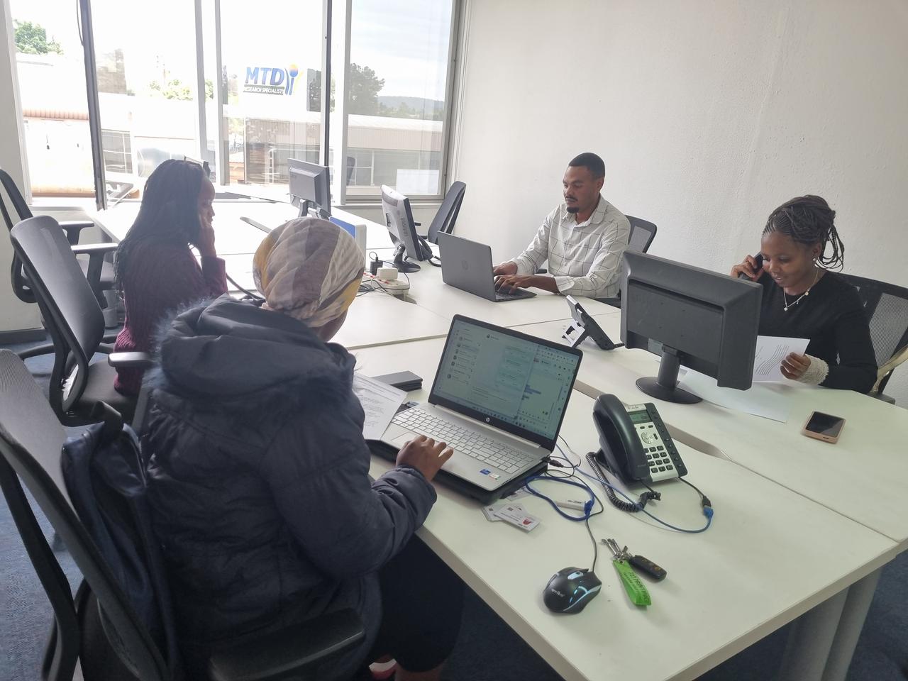 MTD team in branded gear with tablets conducting field research
