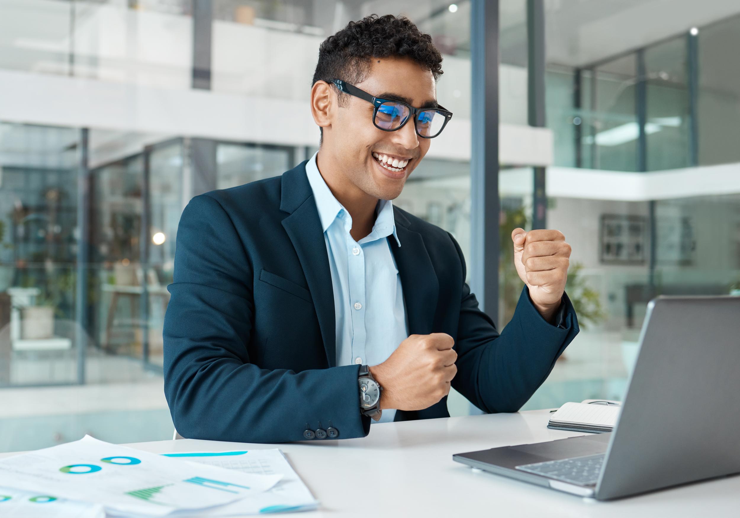 young-mixed-race-businessman-cheering-with-joy-whi-2026-01-09-09-54-46-utc.jpg