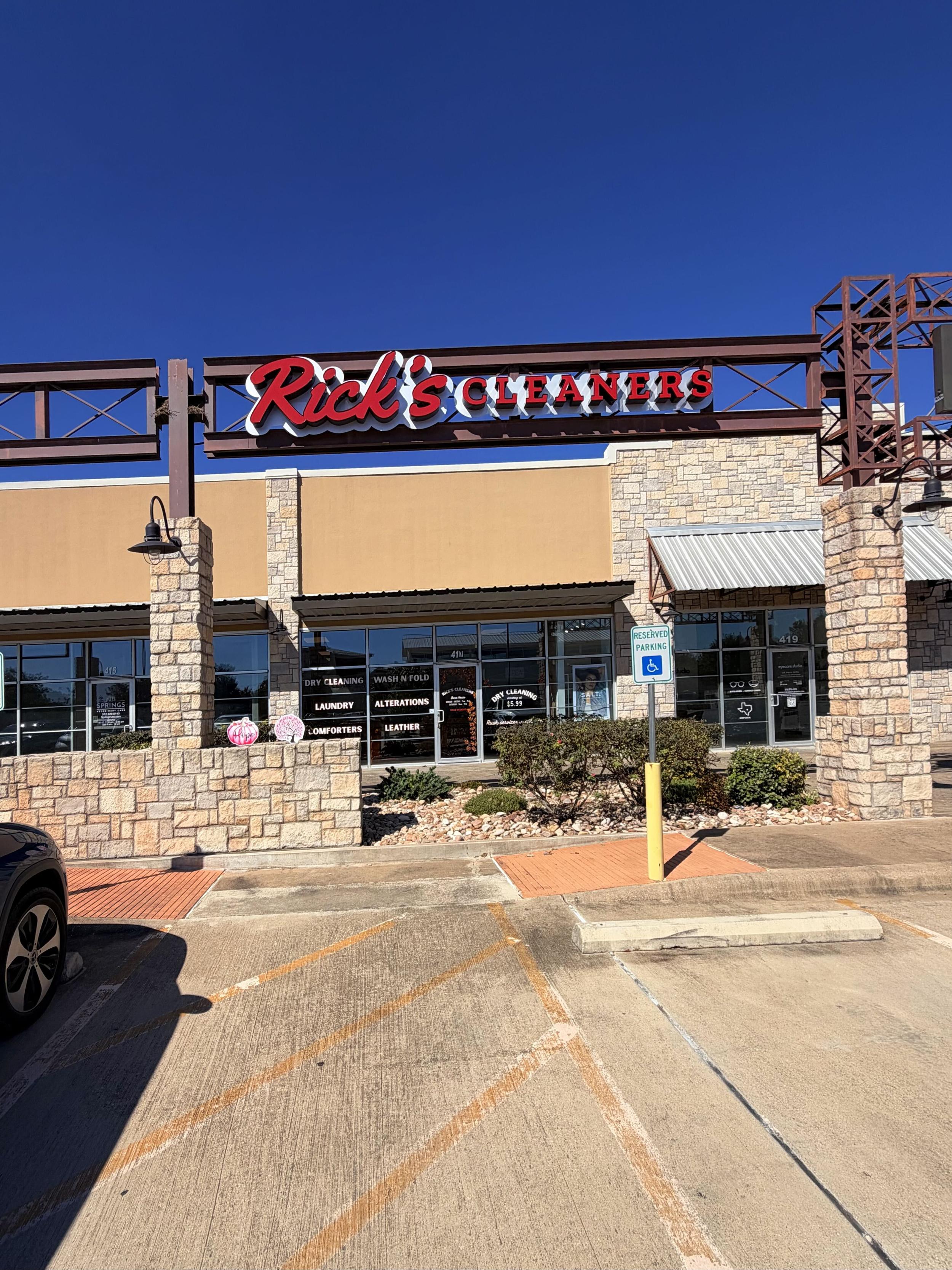 Rick's Cleaners Dripping Springs storefront with sign and parking