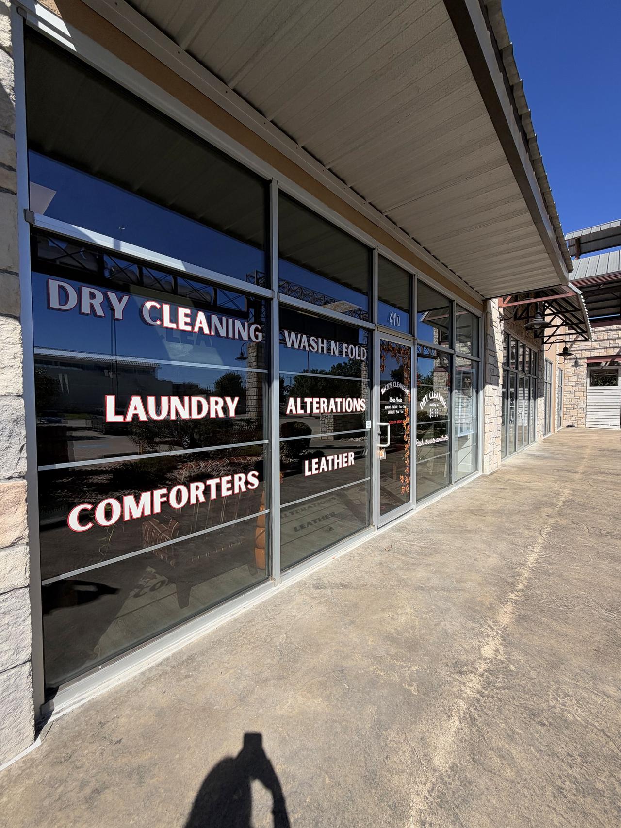 Rick's Cleaners Dripping Springs storefront entrance with services signage