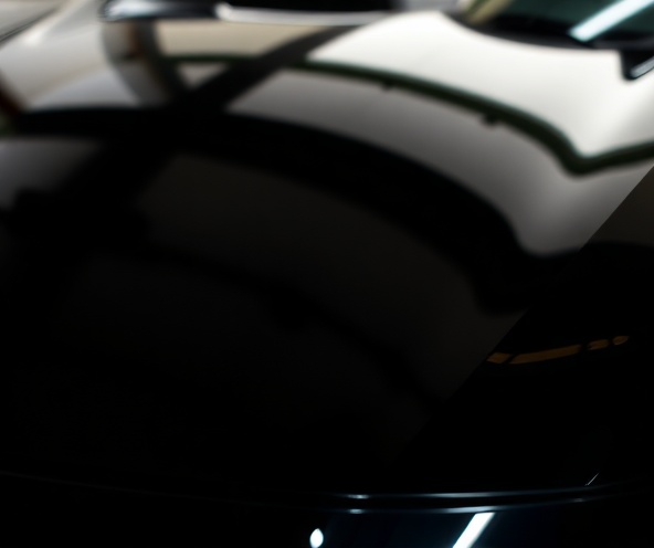 Close-up of perfectly detailed luxury car surface showing shine and reflections