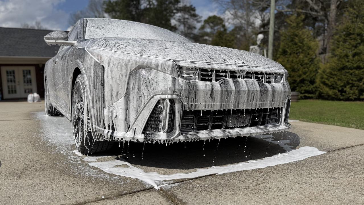 Foam-covered Kia K4 during exterior detailing