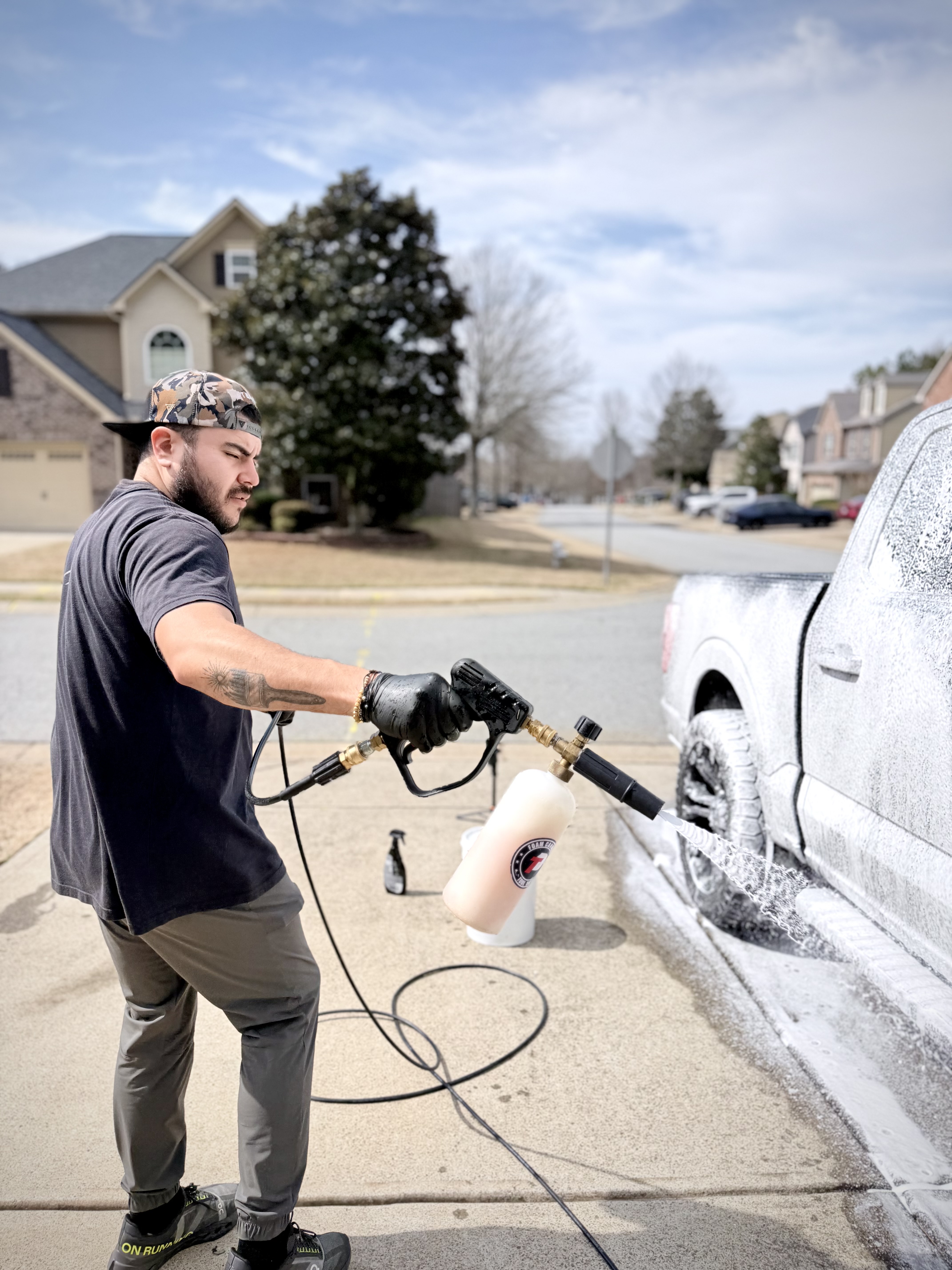 Professional luxury car detailing with foam cannon