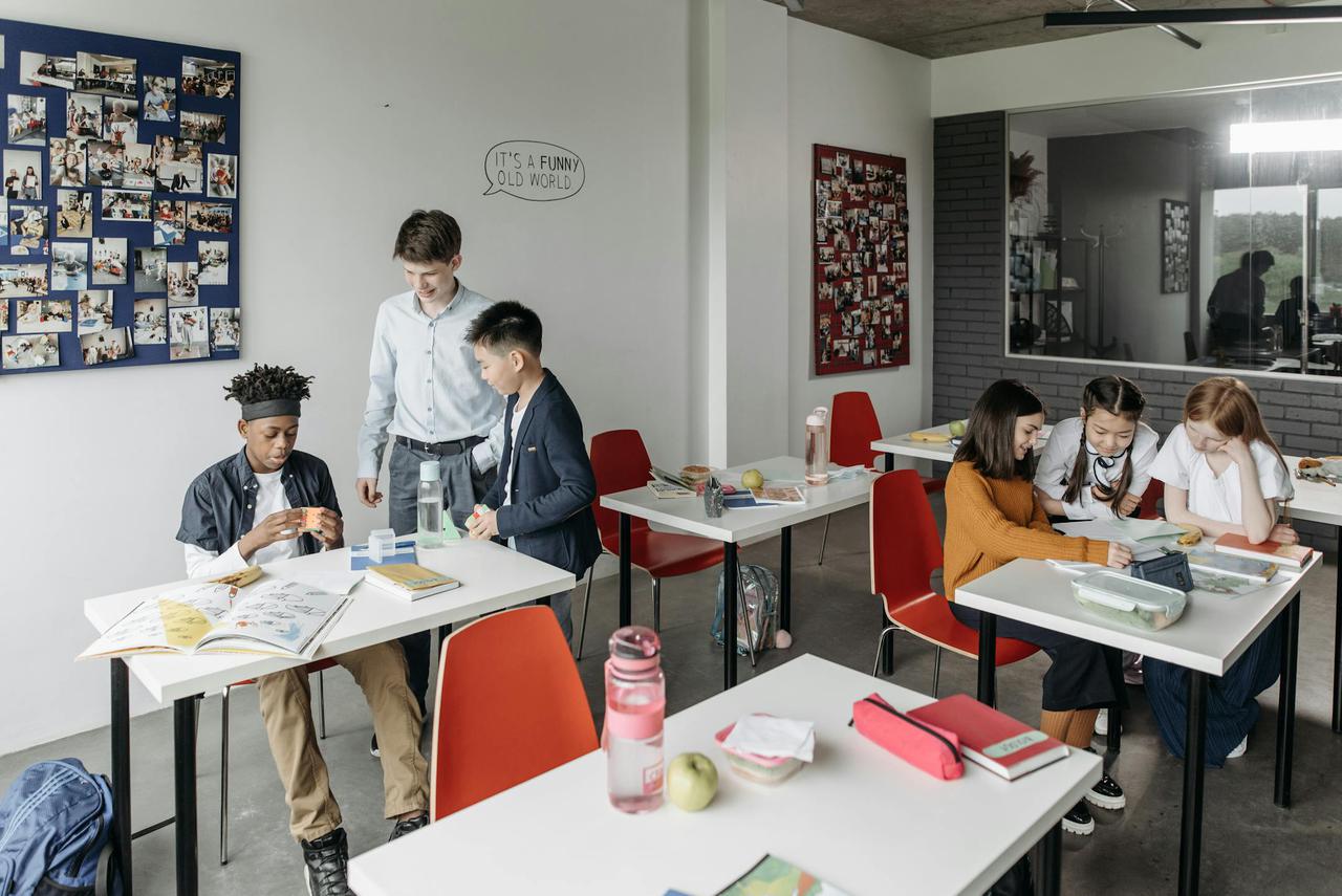 A diverse group of students engaged in a classroom setting, collaborating and studying.