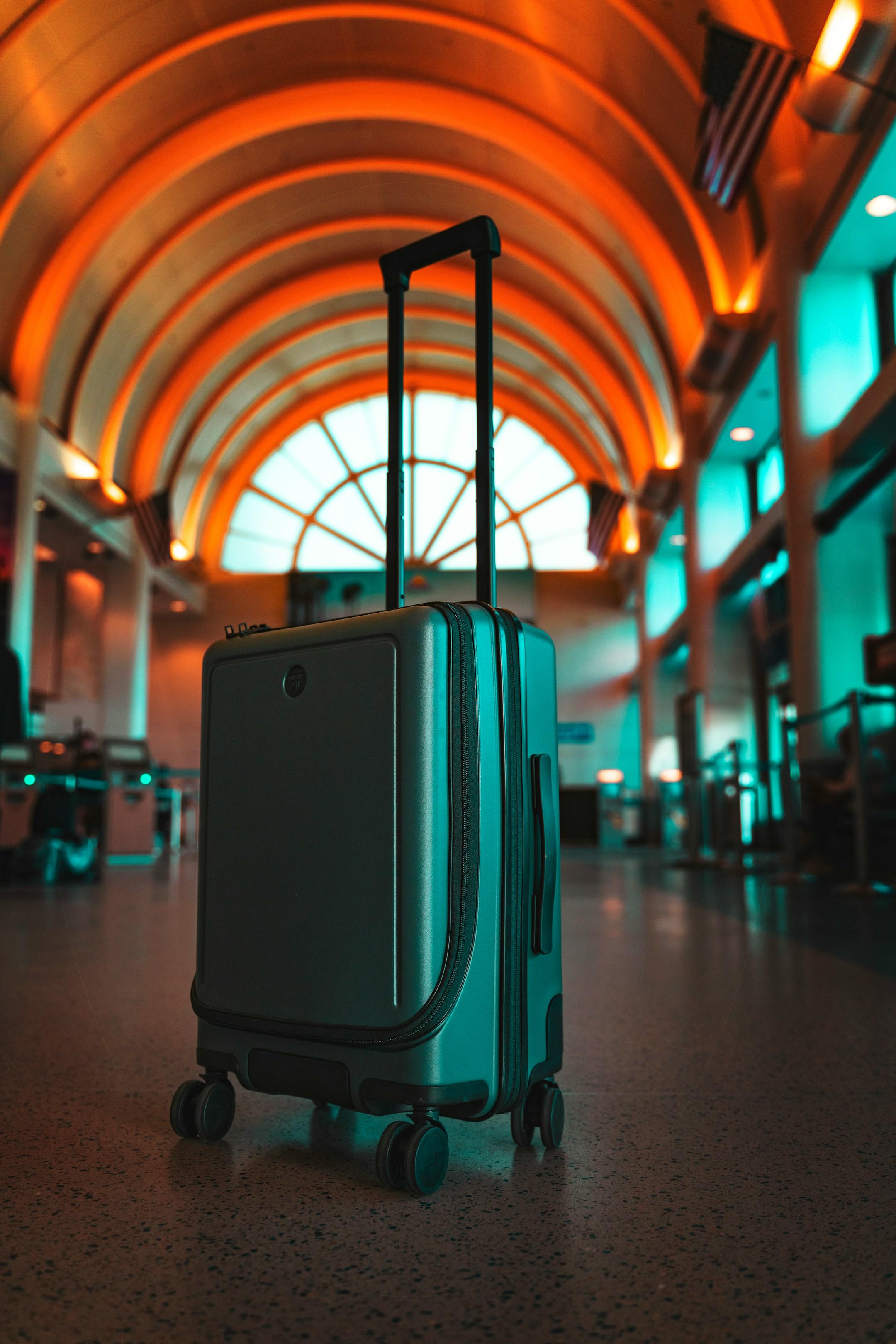 Stylish Travel Luggage In Airport Orange Teal