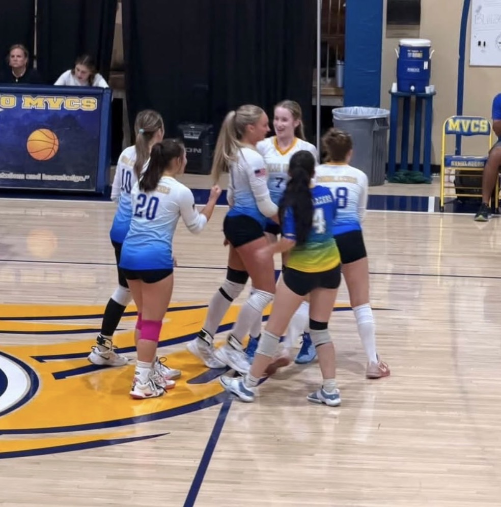 Lady SonBlazers volleyball team celebrating five-set victory