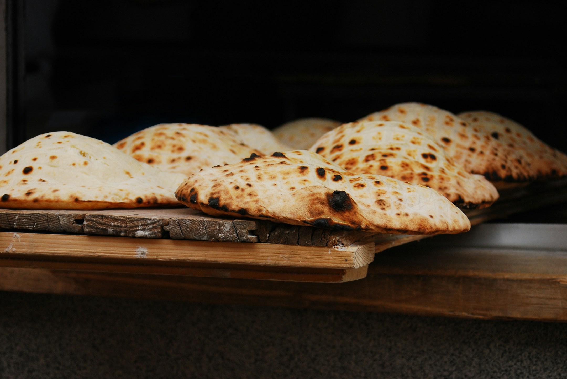 Flat-bread baked in an open fire oven, Serbian-style flatbread, Lepinja, Bosnia and Herzegovina, Sarajevo, fresh bread, warm bread