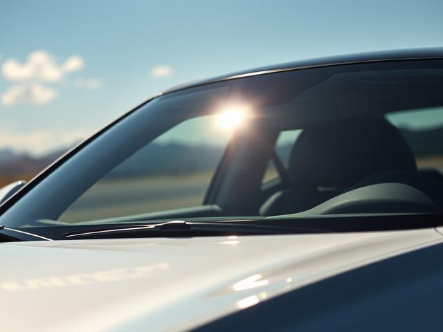 **AI Image Generation Prompt:**

Create a realistic high-resolution photo that visually conveys the benefits of tinting a windshield with clear ceramic film. The image should feature a single, sleek, modern car parked under the bright Las Vegas sun, showcasing the windshield with a clear ceramic tint applied. The composition should be simple and clear, focusing solely on the car and its tinted windshield.

The subject should be positioned at a slight angle, allowing for a detailed view of the windshield whi