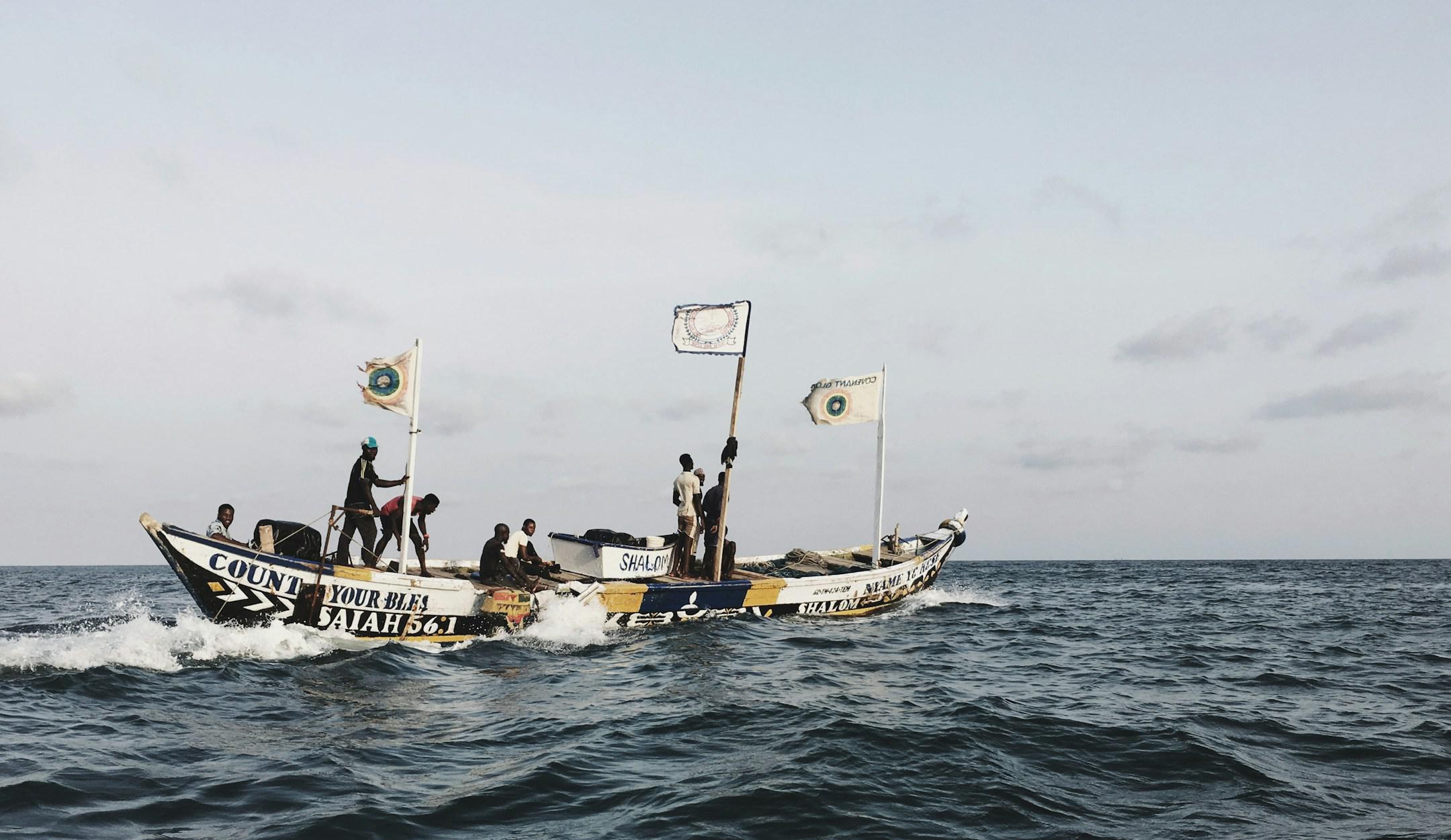 I was working at a vessel, arrived in Ghana last autumn. We were at anchorage area, a few miles away from shore.

To do some shopping we lowered our small rescue boat and went to shore. While we were on our way back to vessel, the sun was about to set and it was the time for the local fishermen to come to the stage. There were around 10 boats like this one, they were sailing out from the port and praying all along at the same time in a ritualistic, loud way. They were going pretty fast, they went along ou
