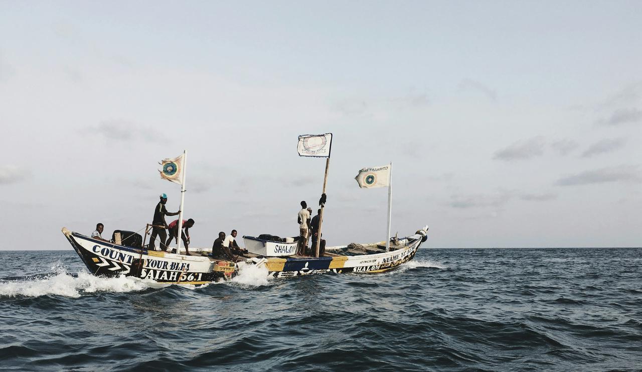 I was working at a vessel, arrived in Ghana last autumn. We were at anchorage area, a few miles away from shore.

To do some shopping we lowered our small rescue boat and went to shore. While we were on our way back to vessel, the sun was about to set and it was the time for the local fishermen to come to the stage. There were around 10 boats like this one, they were sailing out from the port and praying all along at the same time in a ritualistic, loud way. They were going pretty fast, they went along ou