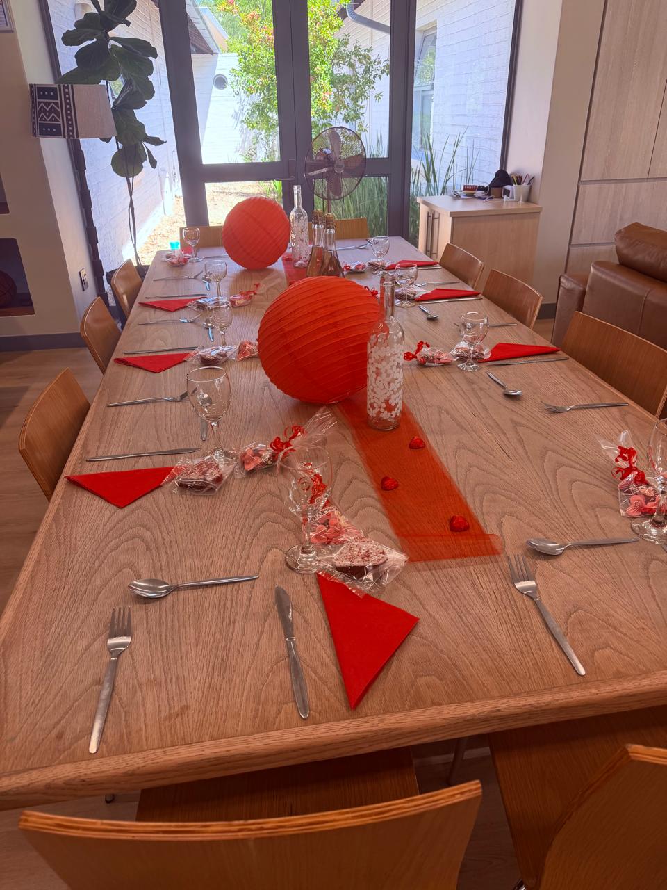 Elegant event table setup with red decorations