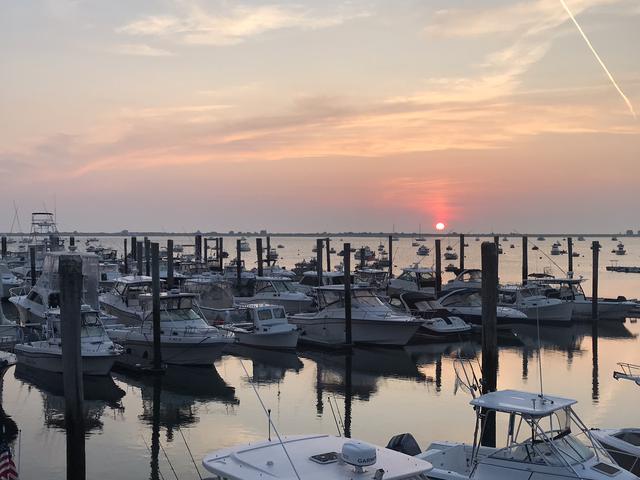 fishing boats docked in plymouth, ma at sunrise