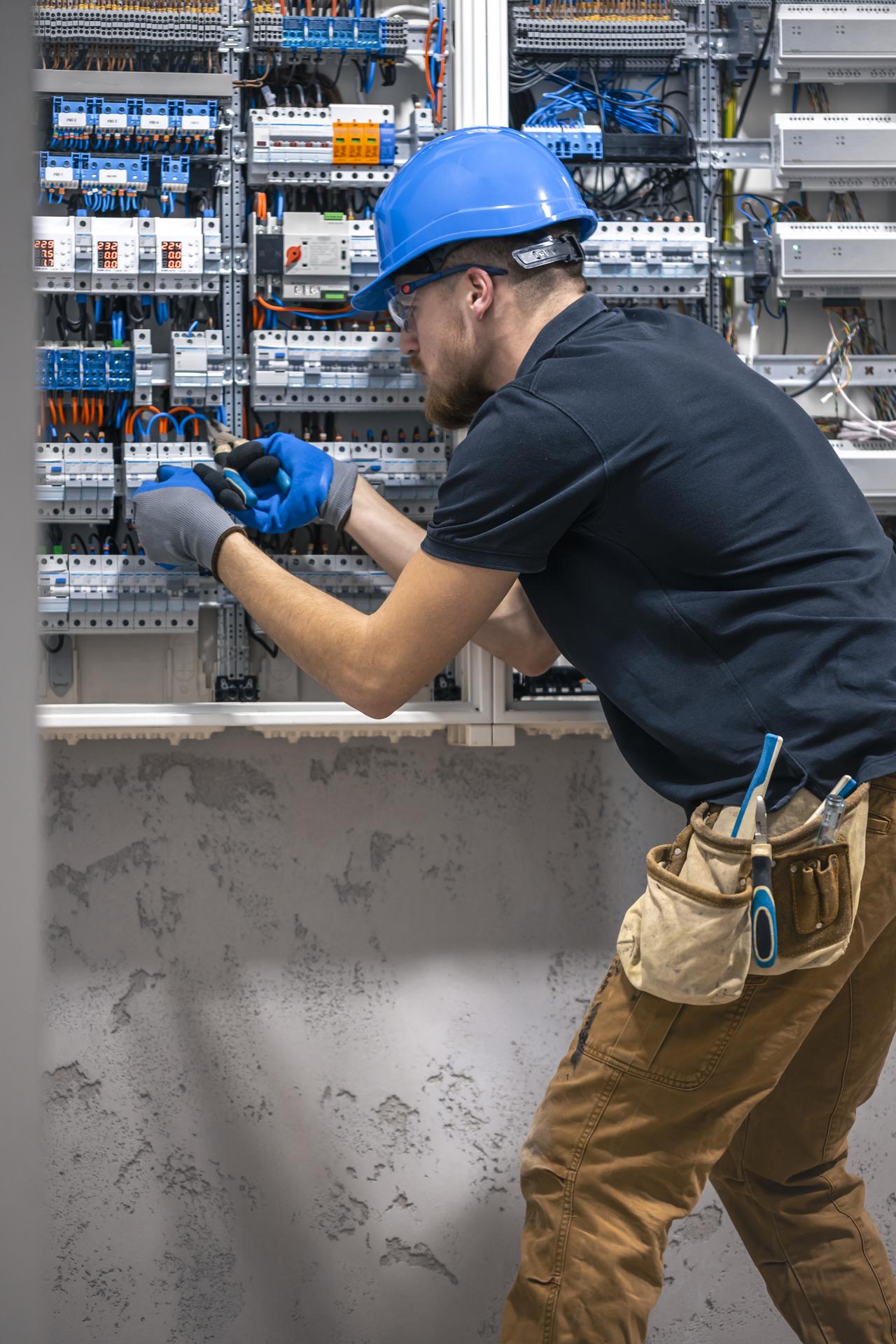 a-male-electrician-works-in-a-switchboard-with-an-2026-01-08-23-46-10-utc.jpg