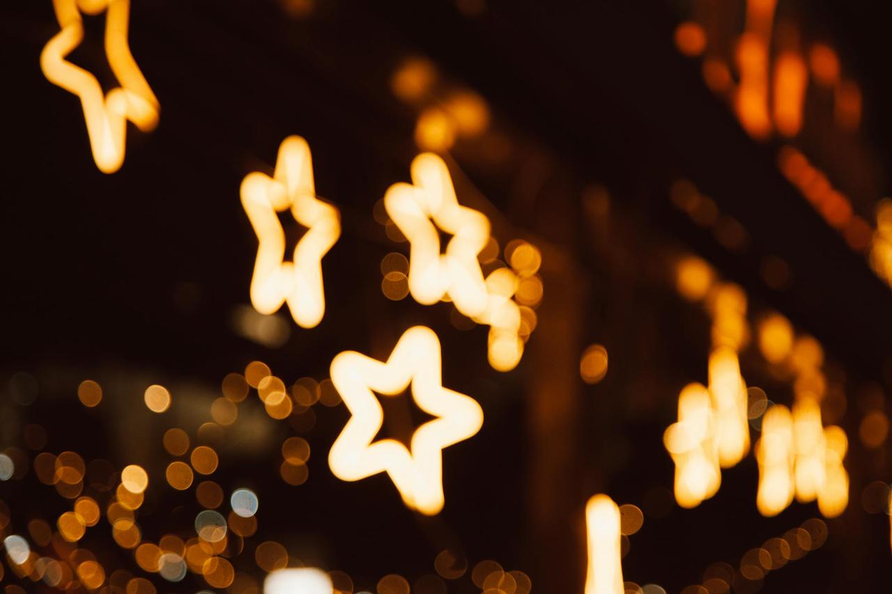Star-shaped bokeh lights creating a warm and festive nighttime atmosphere.