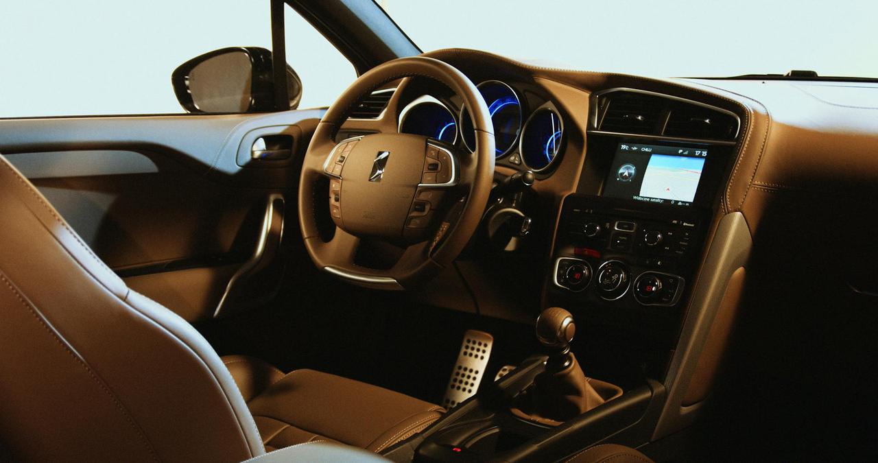 Interior view of a luxury car showcasing a leather seat and illuminated dashboard, featuring modern design elements.
