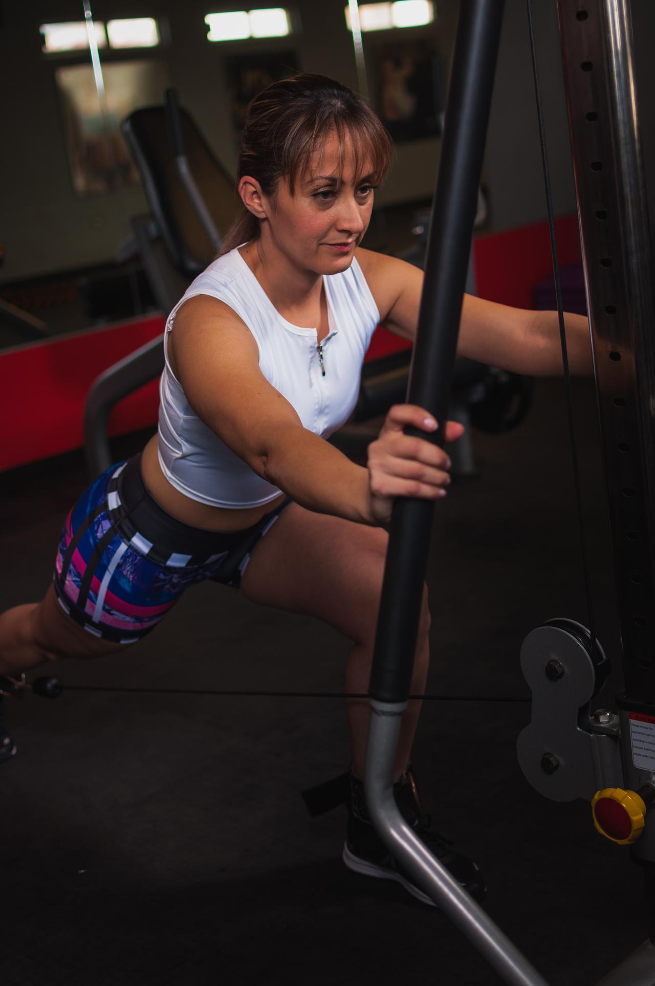 photo-of-woman-working-out-using-gym-equipment-inside-gym-1717097.jpg