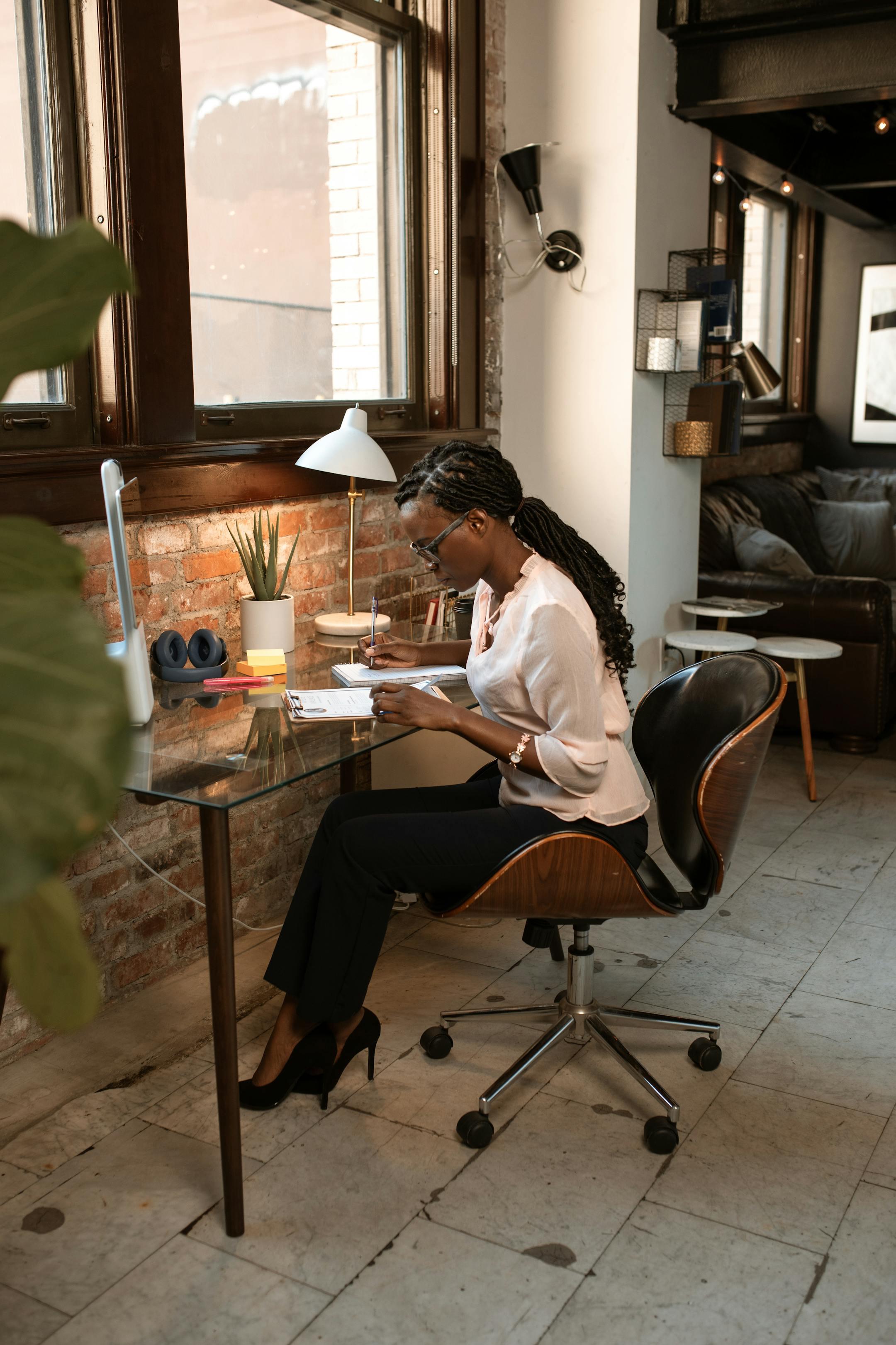 Confident African woman working diligently at a stylish office desk.