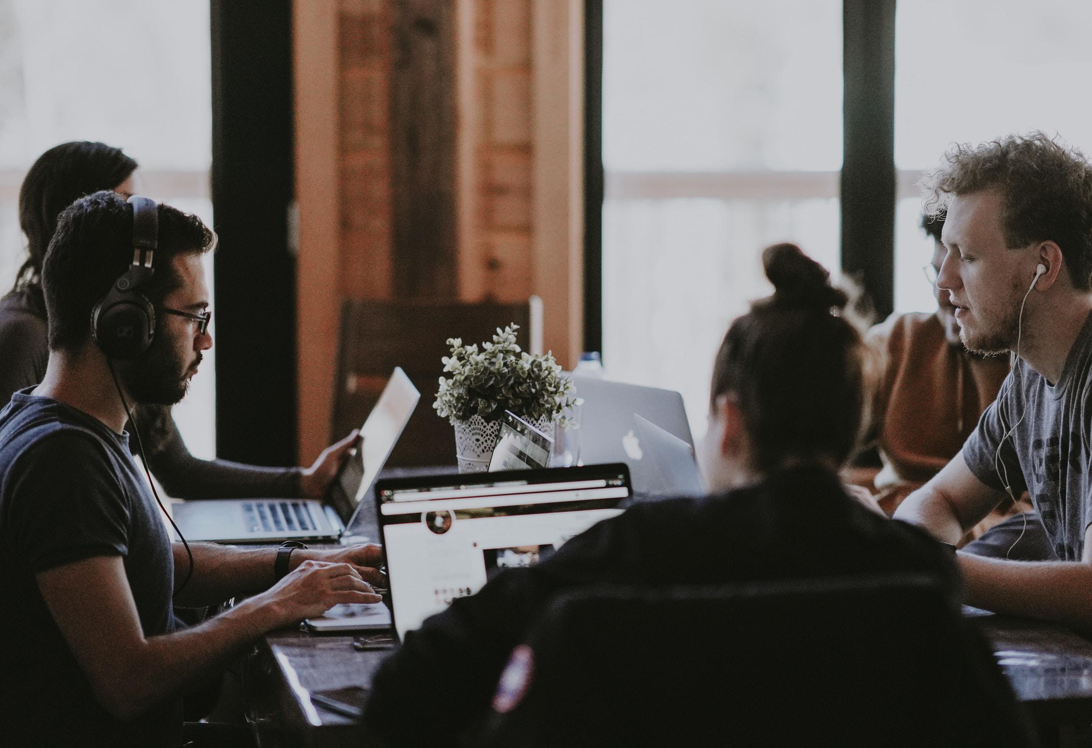 A diligent team working on laptops at a table. Our effective networking solutions will put you in contact with everyone and anyone you need to know.