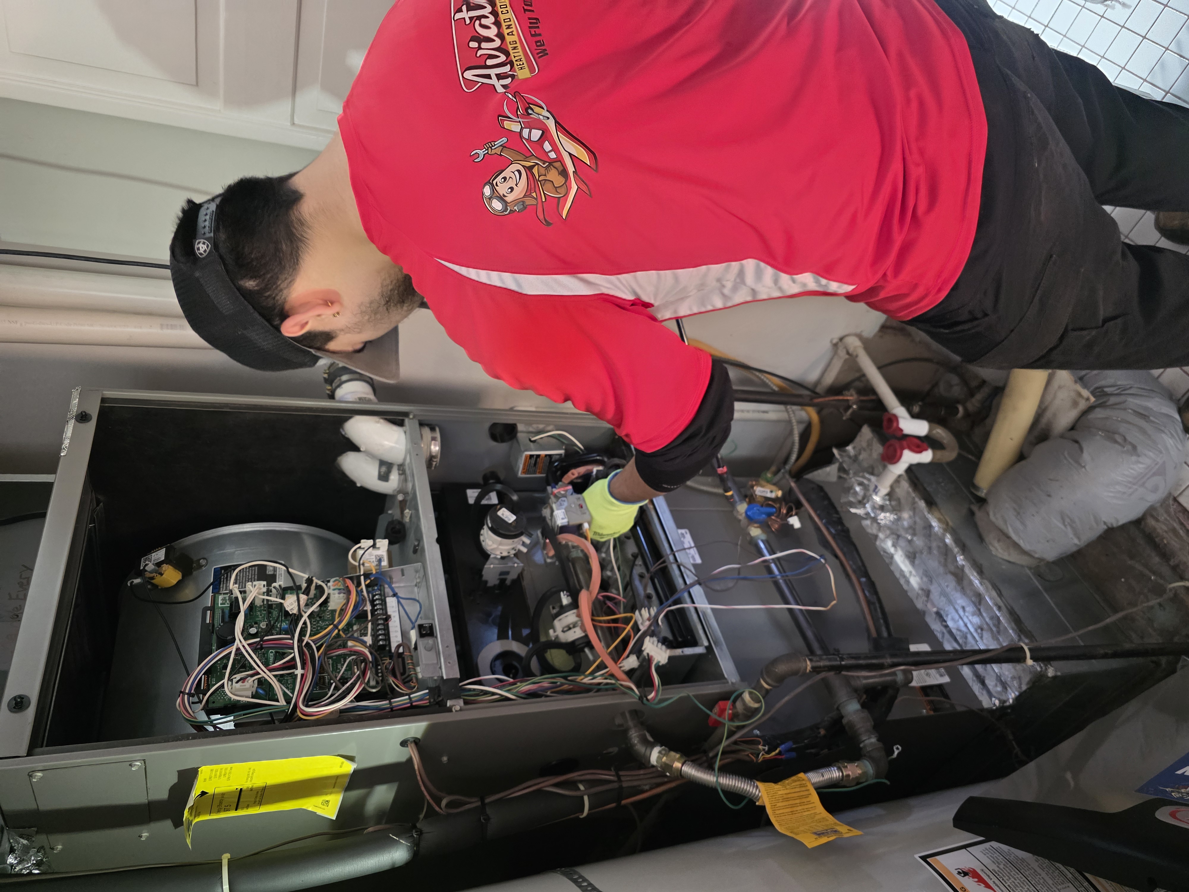 Professional HVAC repair technician working on heating and cooling system in Beaverton