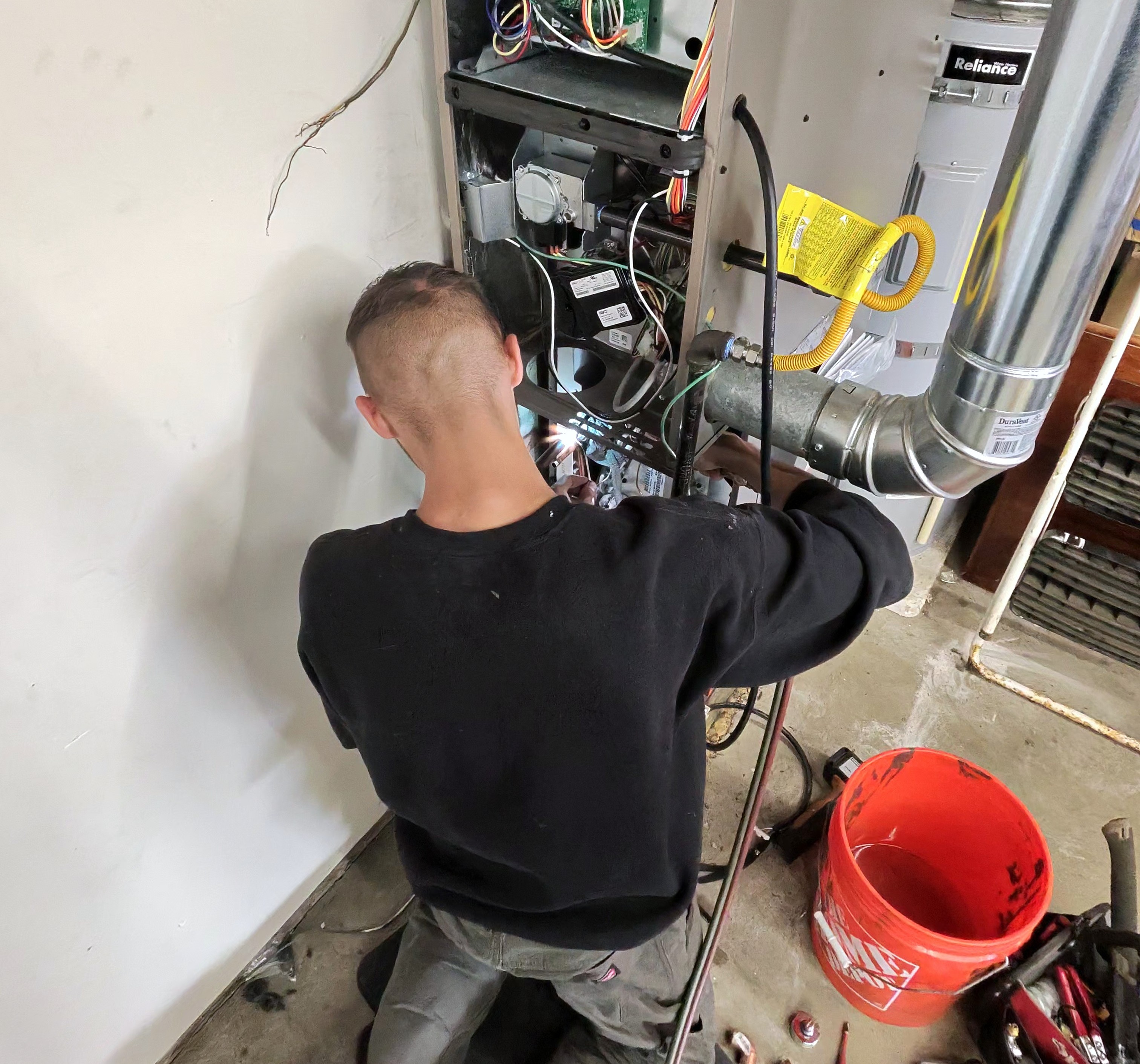 Professional HVAC technician performing furnace repair