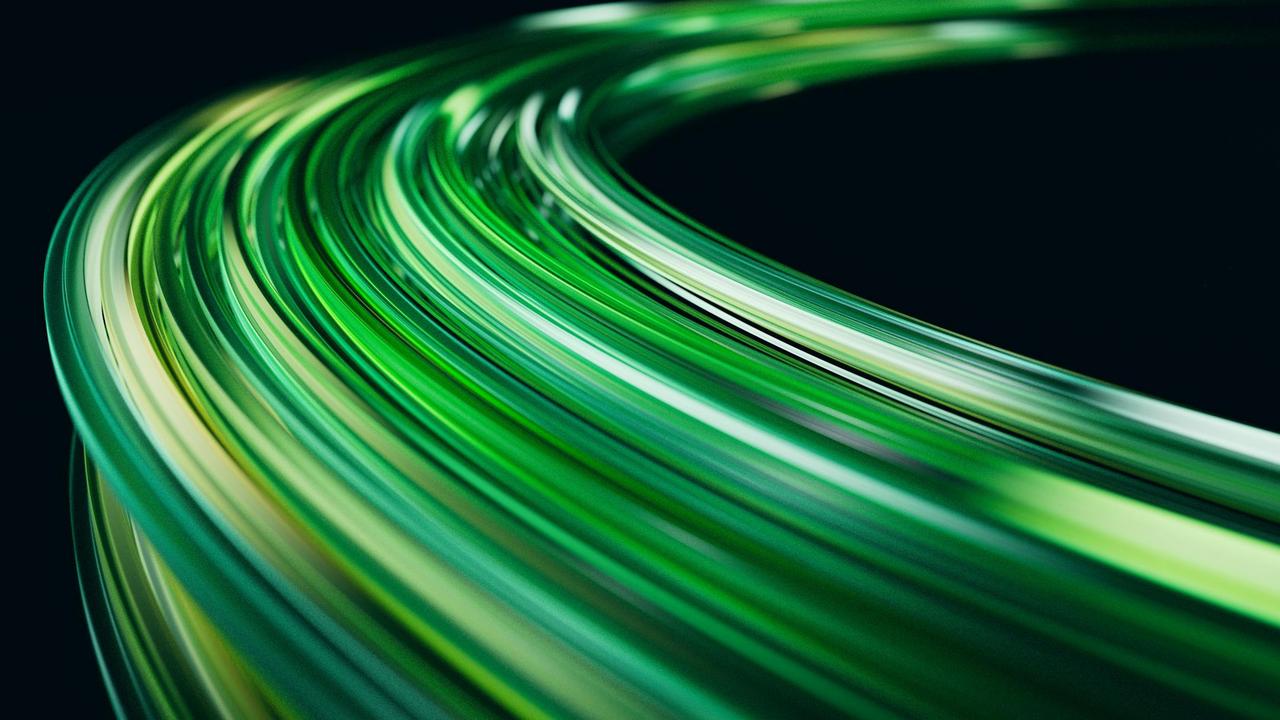 Abstract image of green light trails on a dark background, creating a sense of motion.