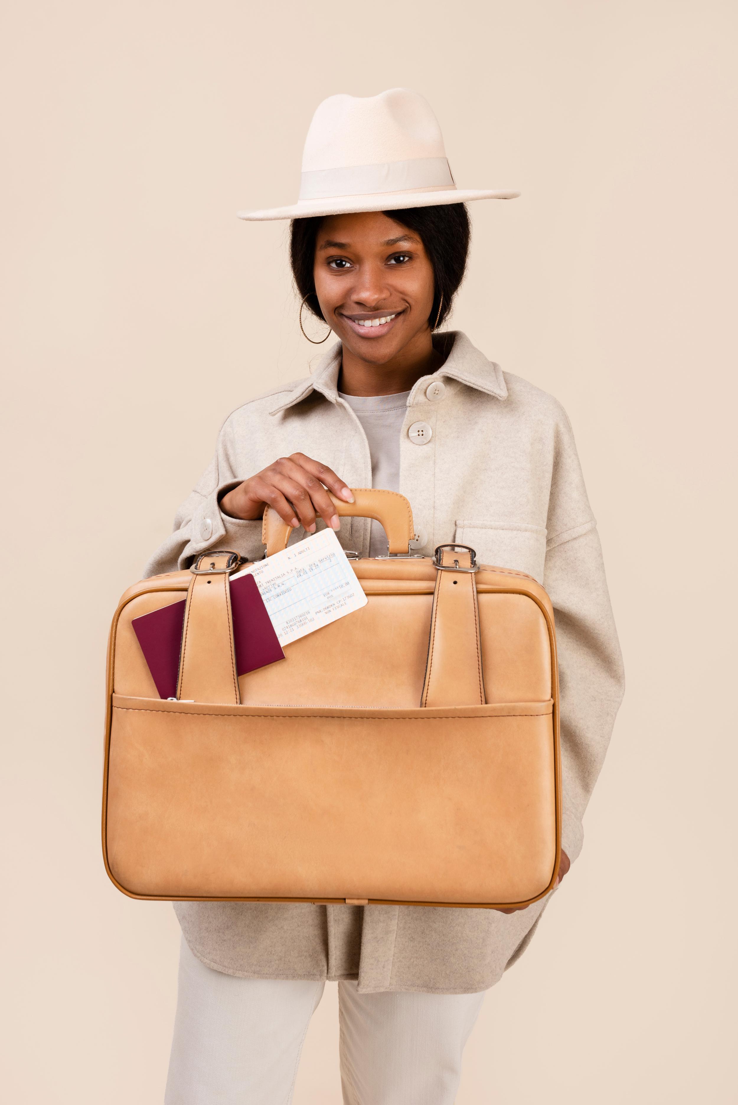 medium-shot-smiley-woman-holding-baggage.jpeg