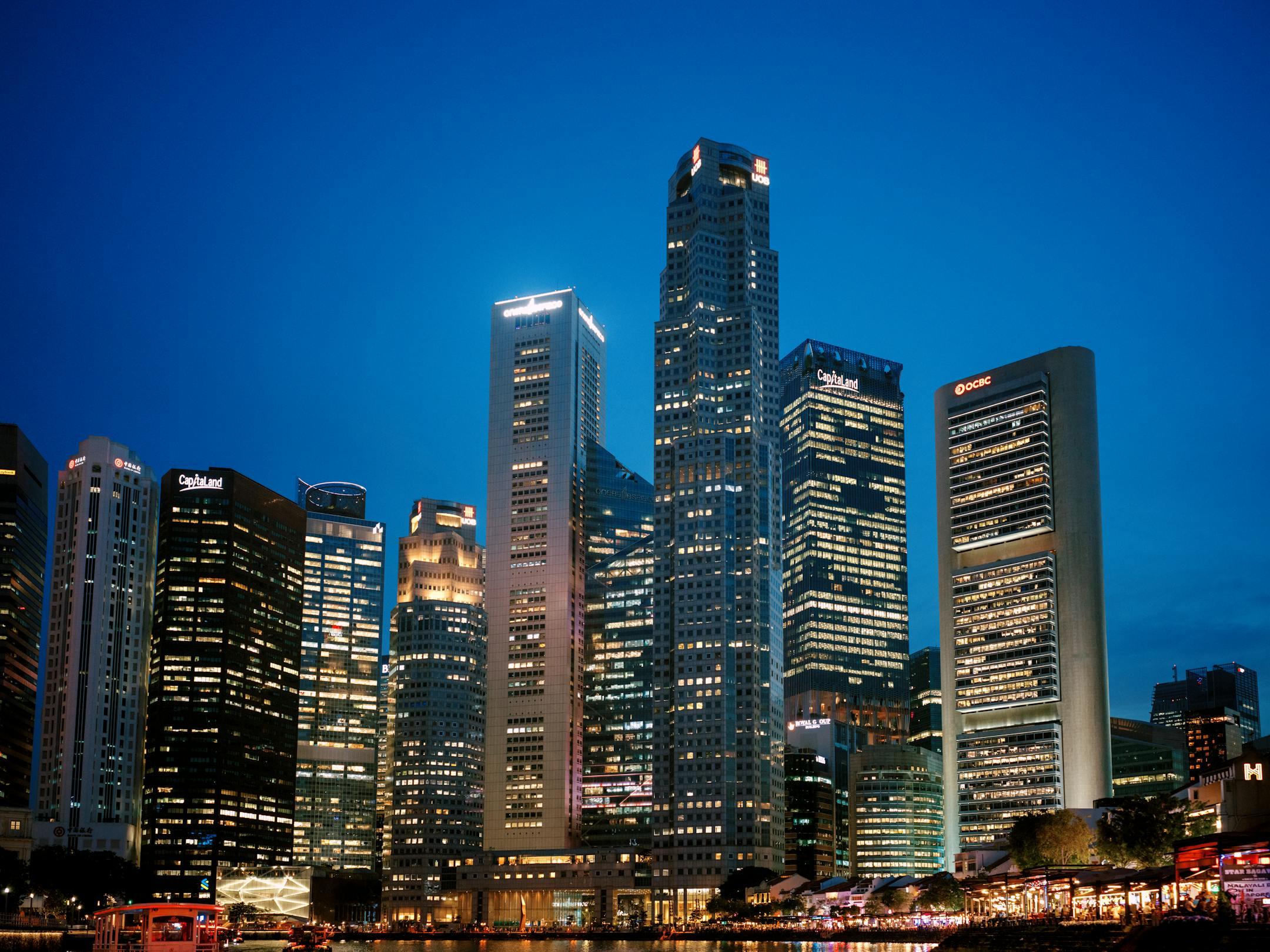 Stunning view of Singapore's financial district skyline at night with illuminated skyscrapers.