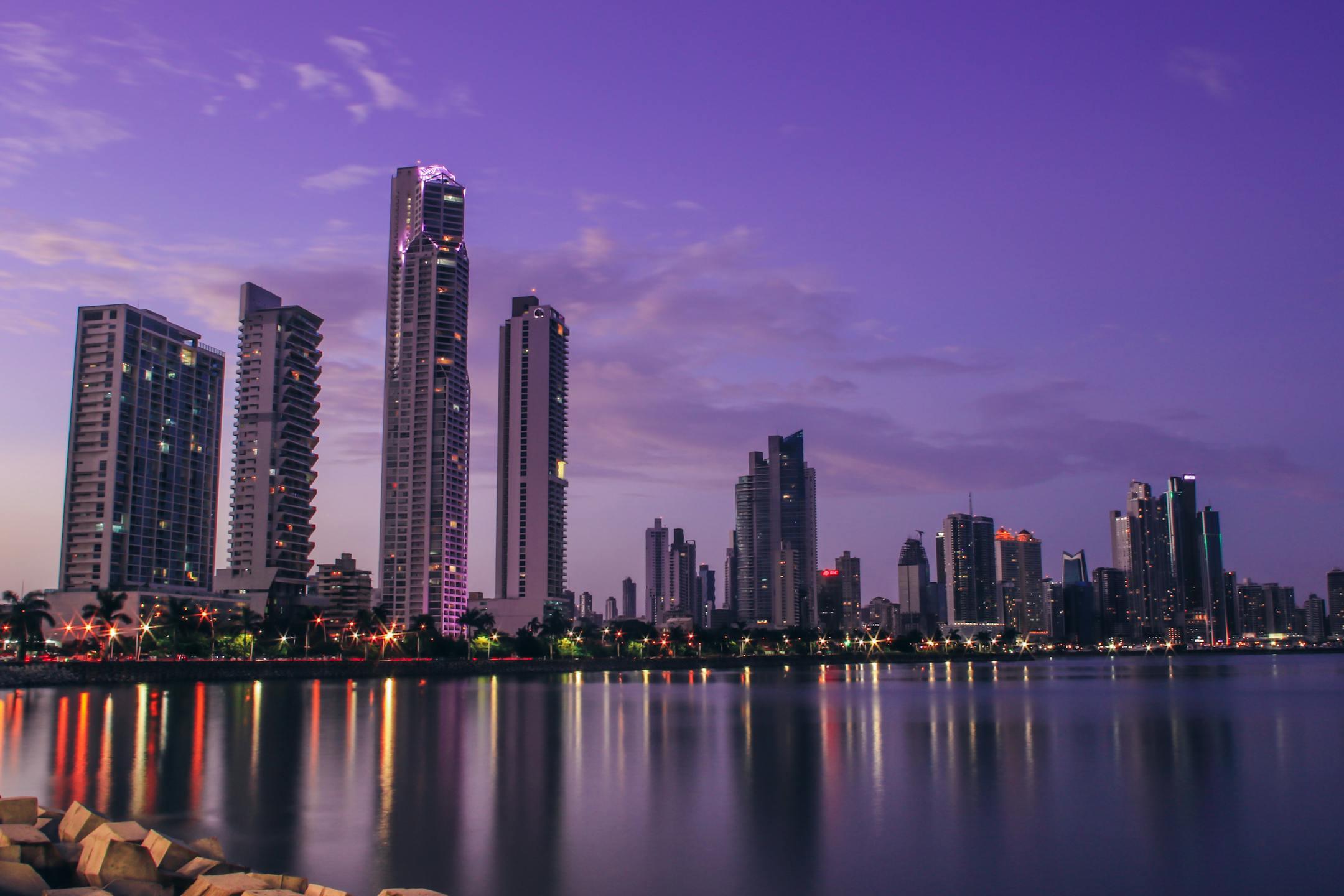Stunning Panama City skyline reflecting on water at twilight, showcasing modern architecture.