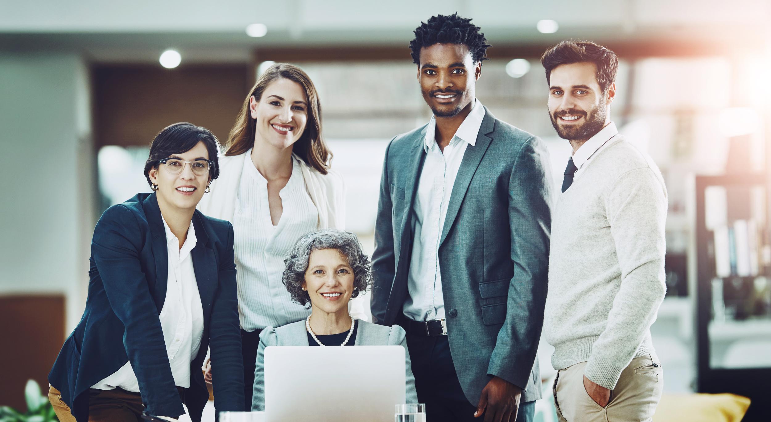 professional-team-posing-in-workplace-with-laptop-2026-03-25-04-34-08-utc.jpg