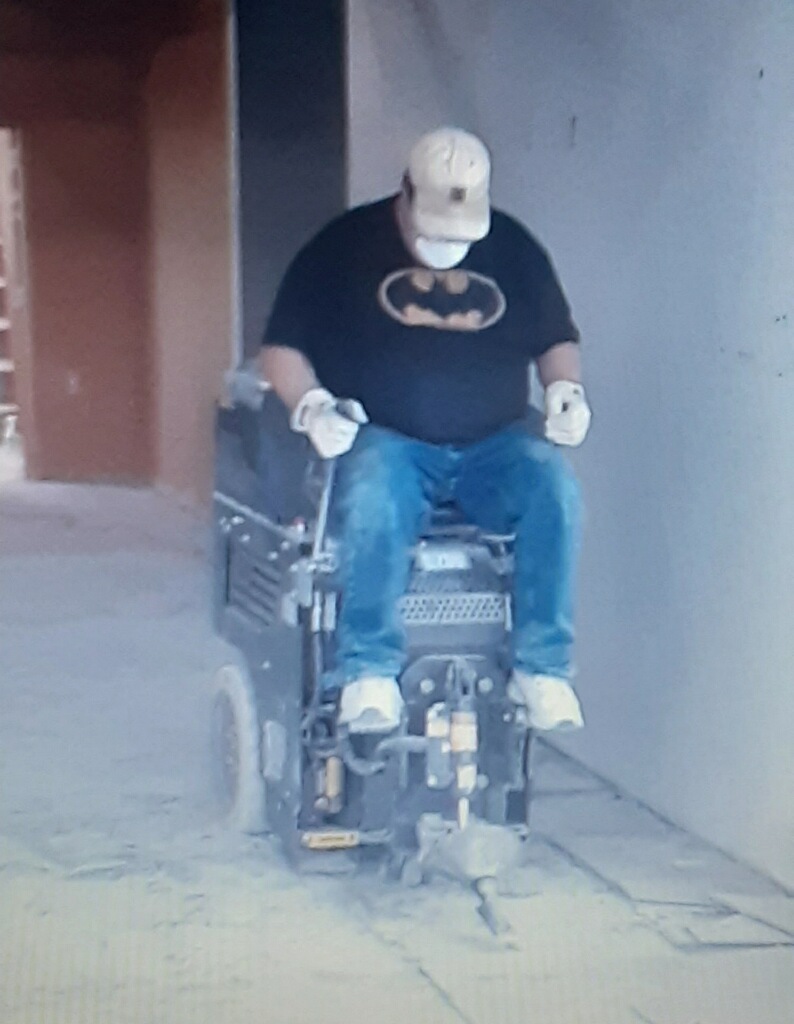 Employee removing flooring during renovation project