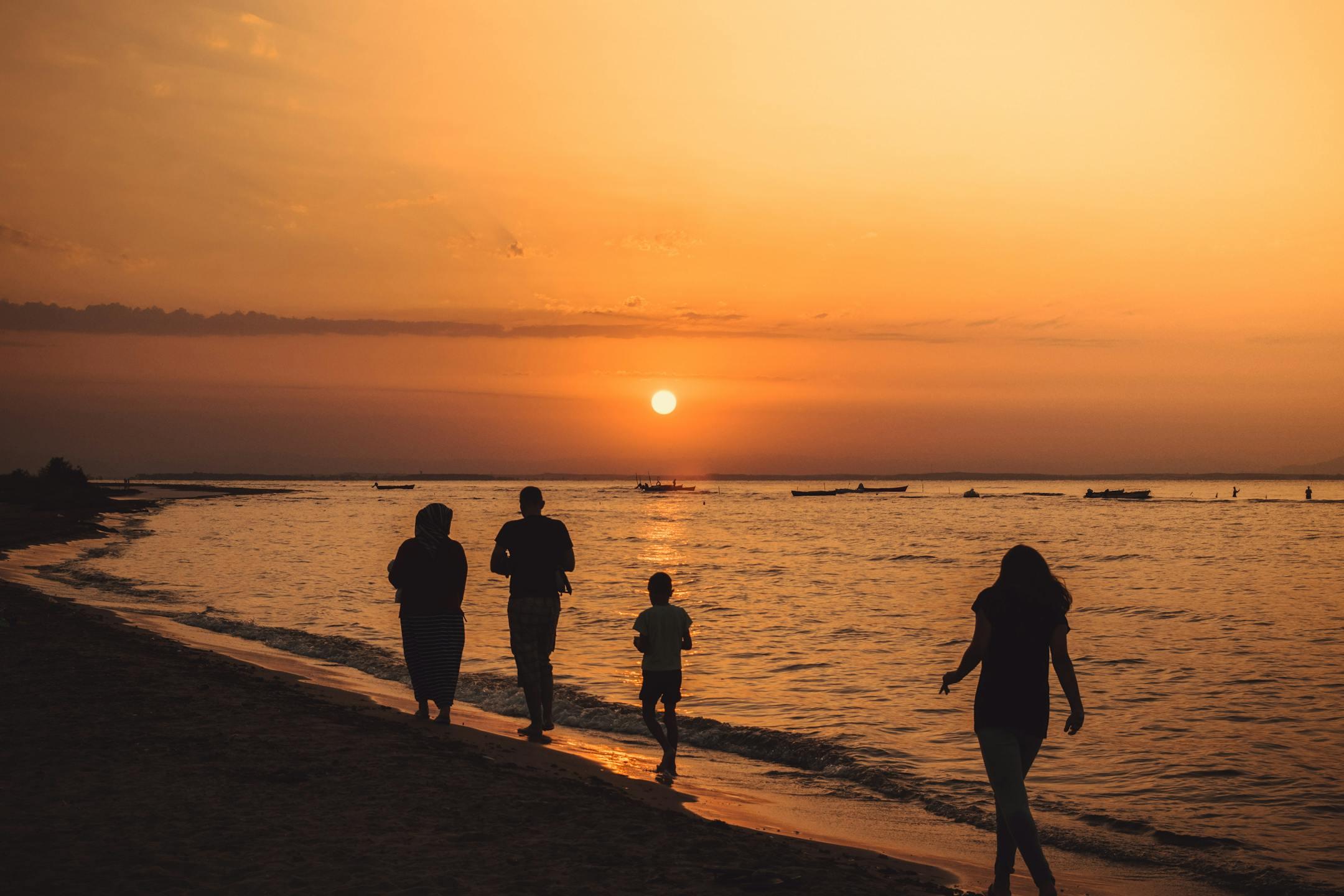 Family walking along Beirut Beach at sunset—Cognitive Analytica family therapy promoting connection, empathy, and healing for Lebanese families (in-person & online).