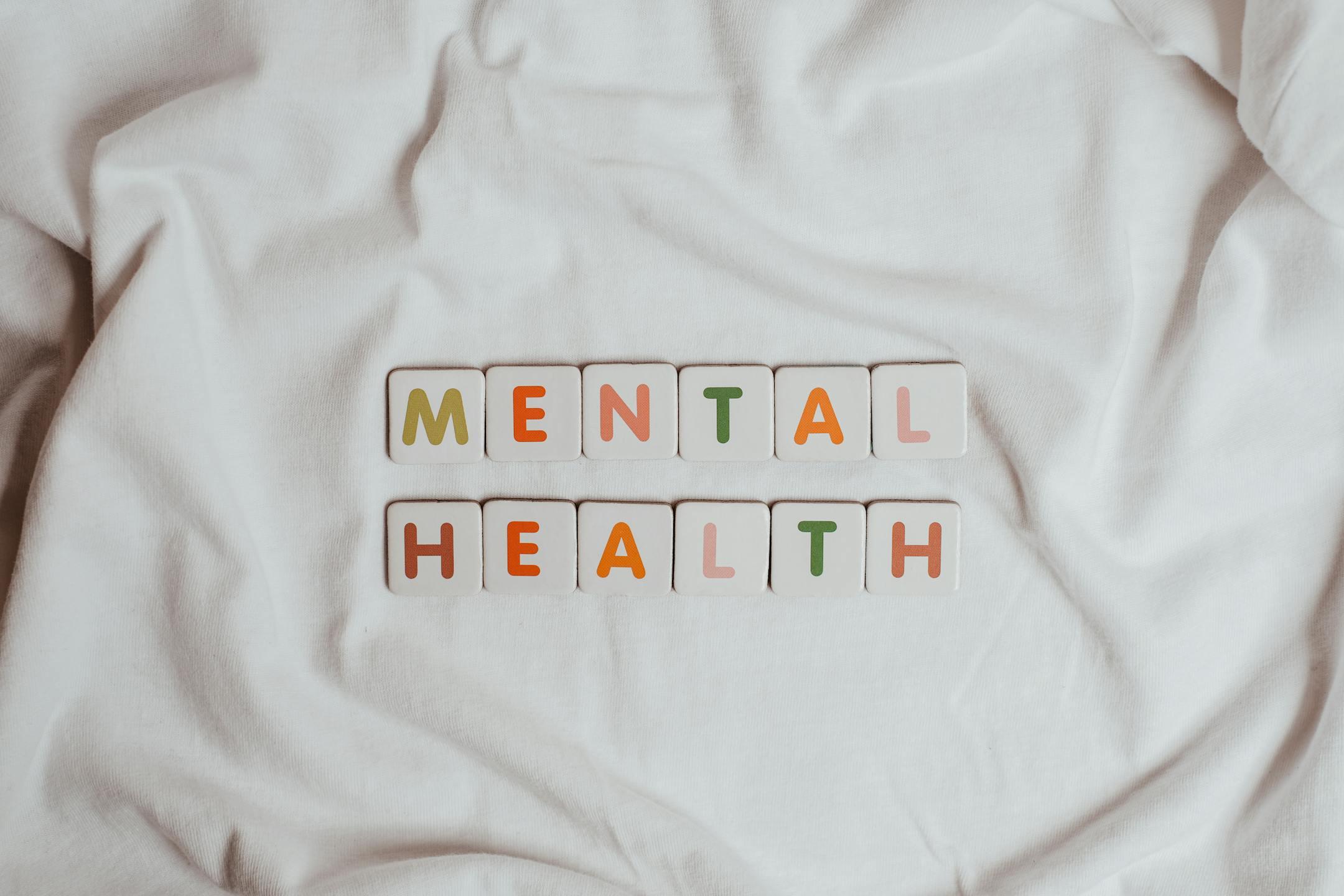 Close-up of the words <em>“Mental Health”</em> printed on cloth, symbolizing calmness, softness, and Cognitive Analytica’s compassionate approach to promoting self-care and emotional balance in Lebanon.