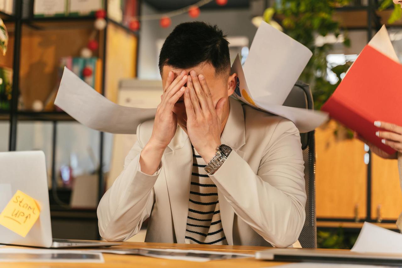 <em>Stressed businessman in Beirut representing work-related anxiety and burnout treated with psychotherapy in Lebanon</em>