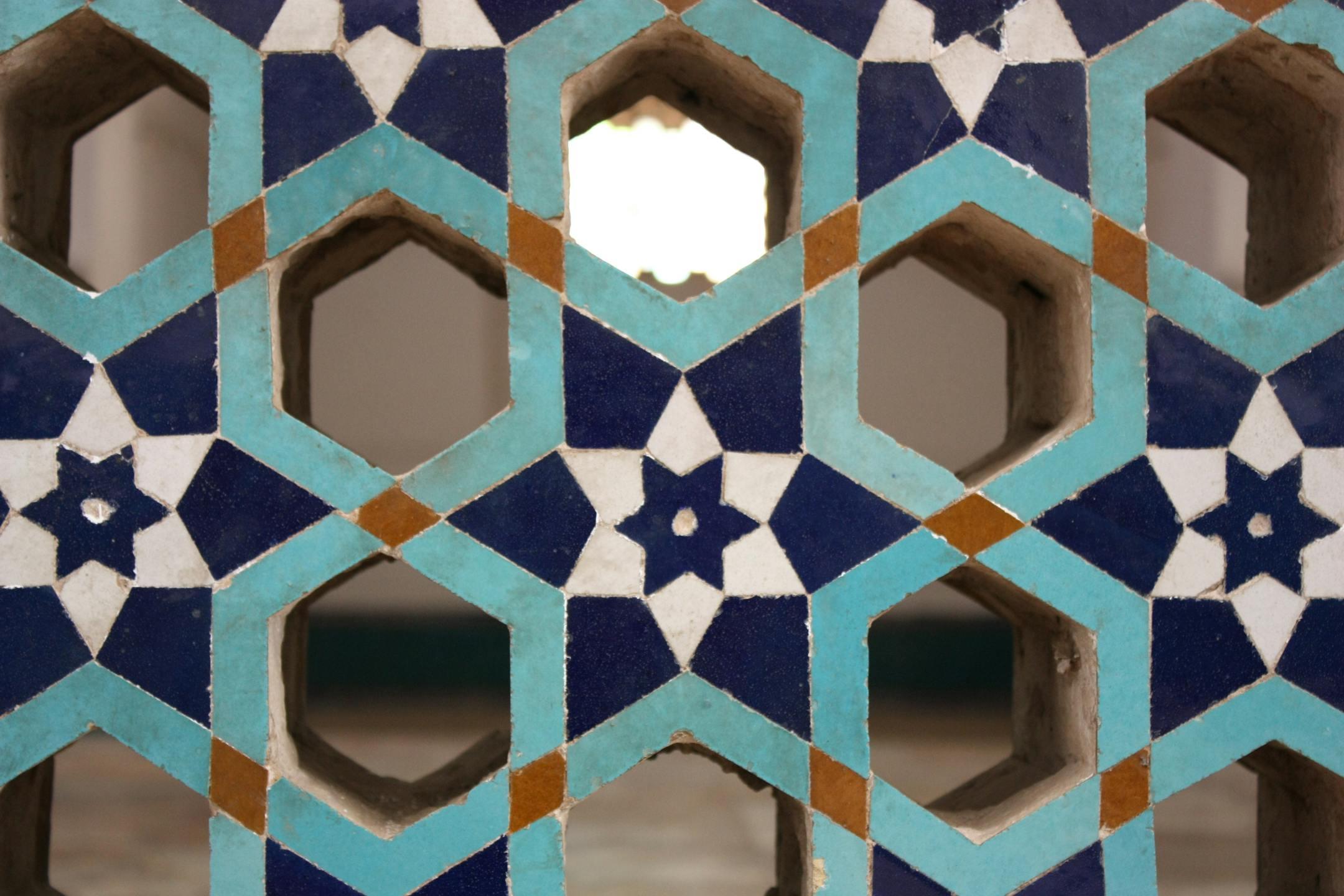 Close-up of a vibrant Islamic tile pattern in Shiraz, Iran, showcasing traditional geometry.