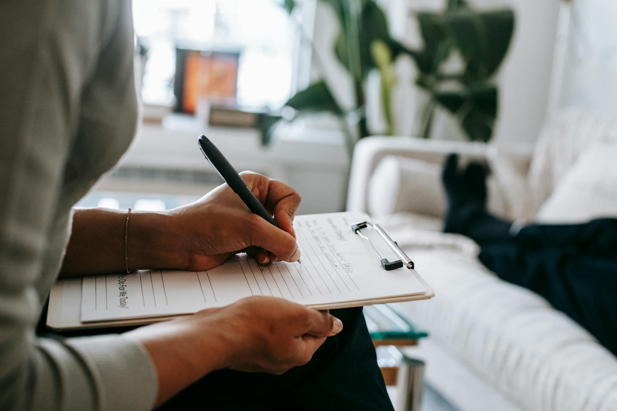 A Cognitive Analytica therapist in Lebanon taking notes during a psychotherapy session, reflecting professionalism, confidentiality, and evidence-based therapeutic practice.