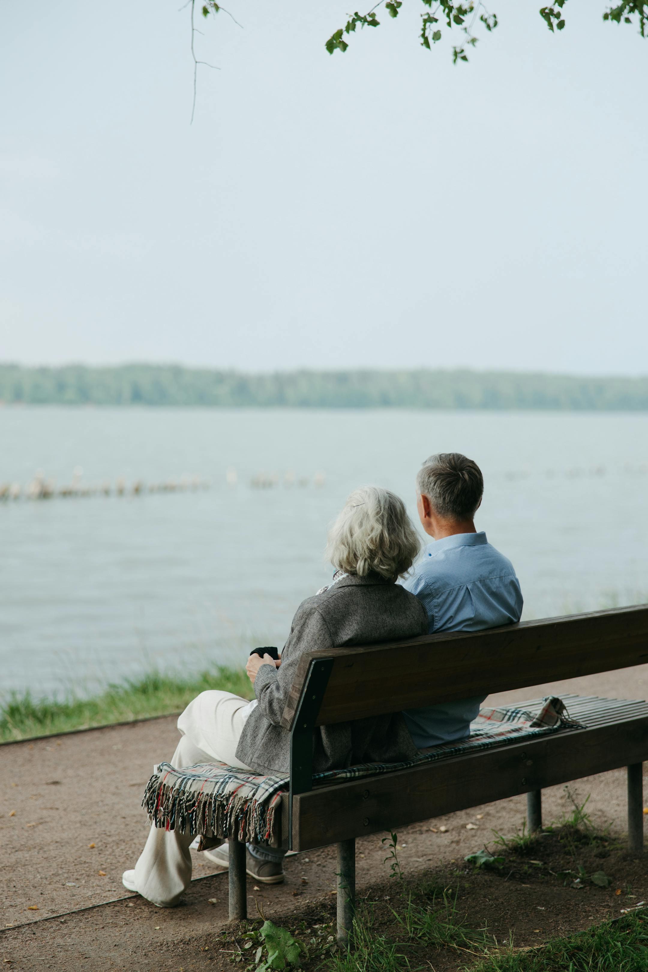 Senior couple sitting on a bench by the lake, Cognitive Analytica clients finding renewed peace and emotional balance through couples therapy in Lebanon
