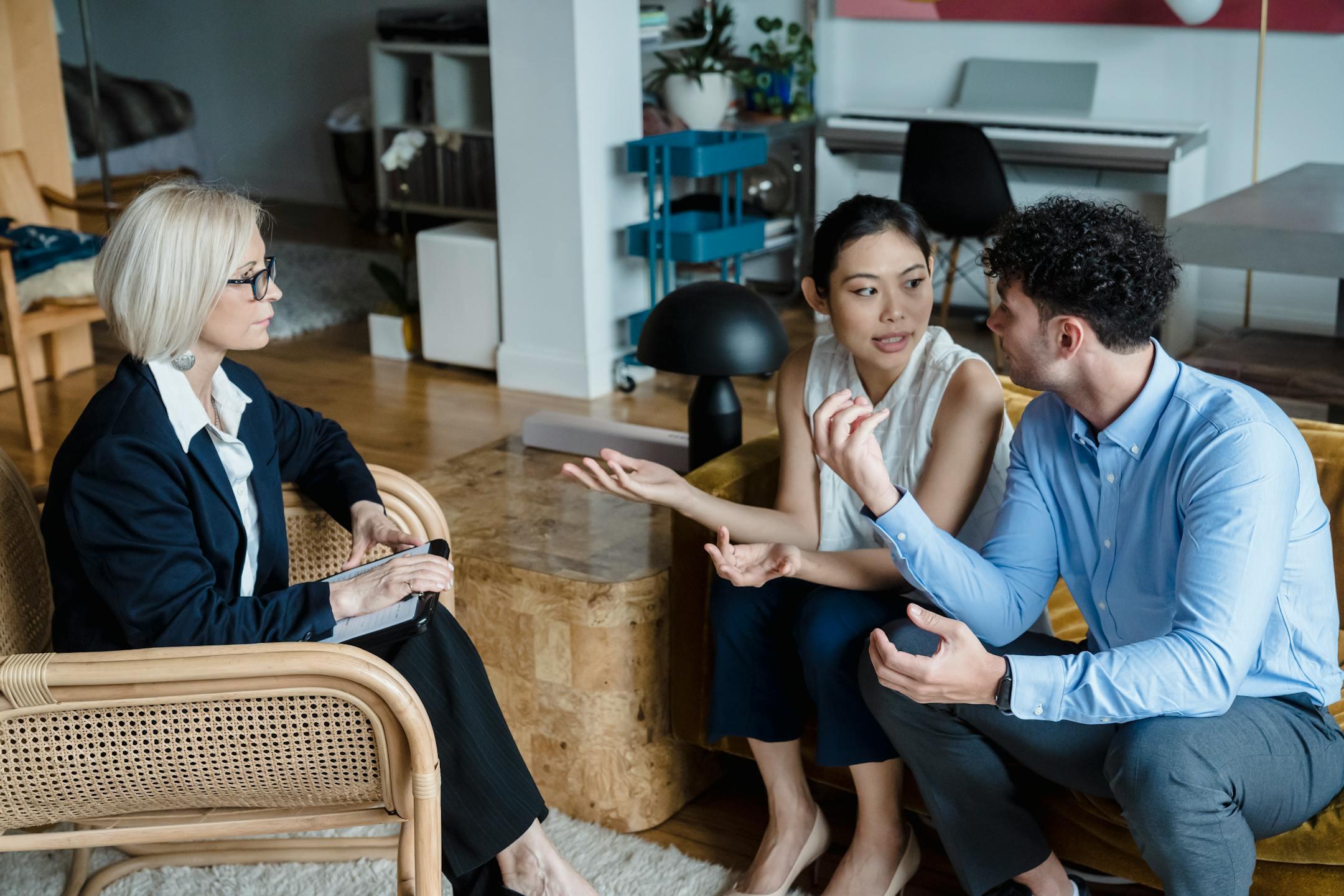 A couple speaking with a therapist in a modern living room, Cognitive Analytica family therapy in Lebanon supporting communication, understanding, and guided conflict resolution.