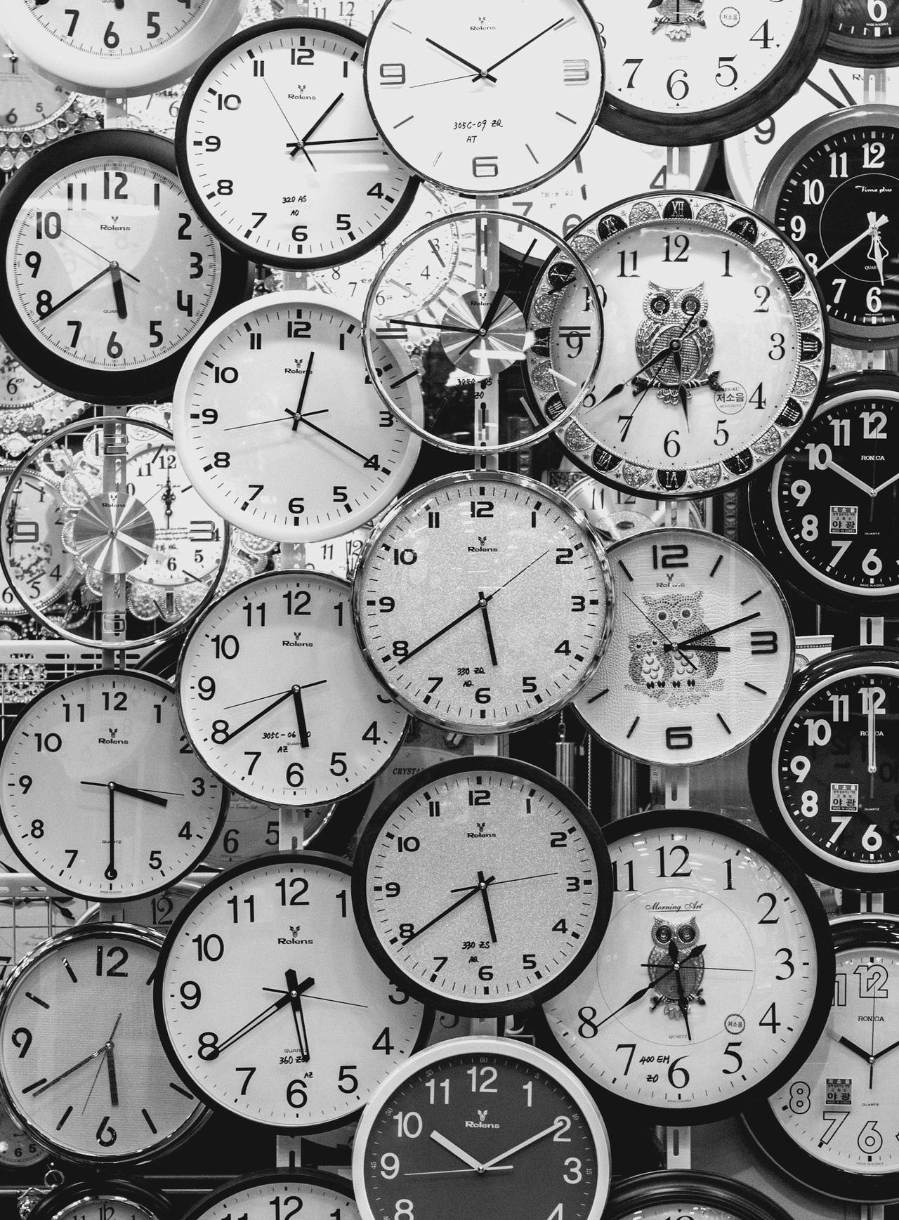 Black and white image of vintage wall clocks representing flexible appointment scheduling and timely therapy sessions at Cognitive Analytica in Lebanon and online