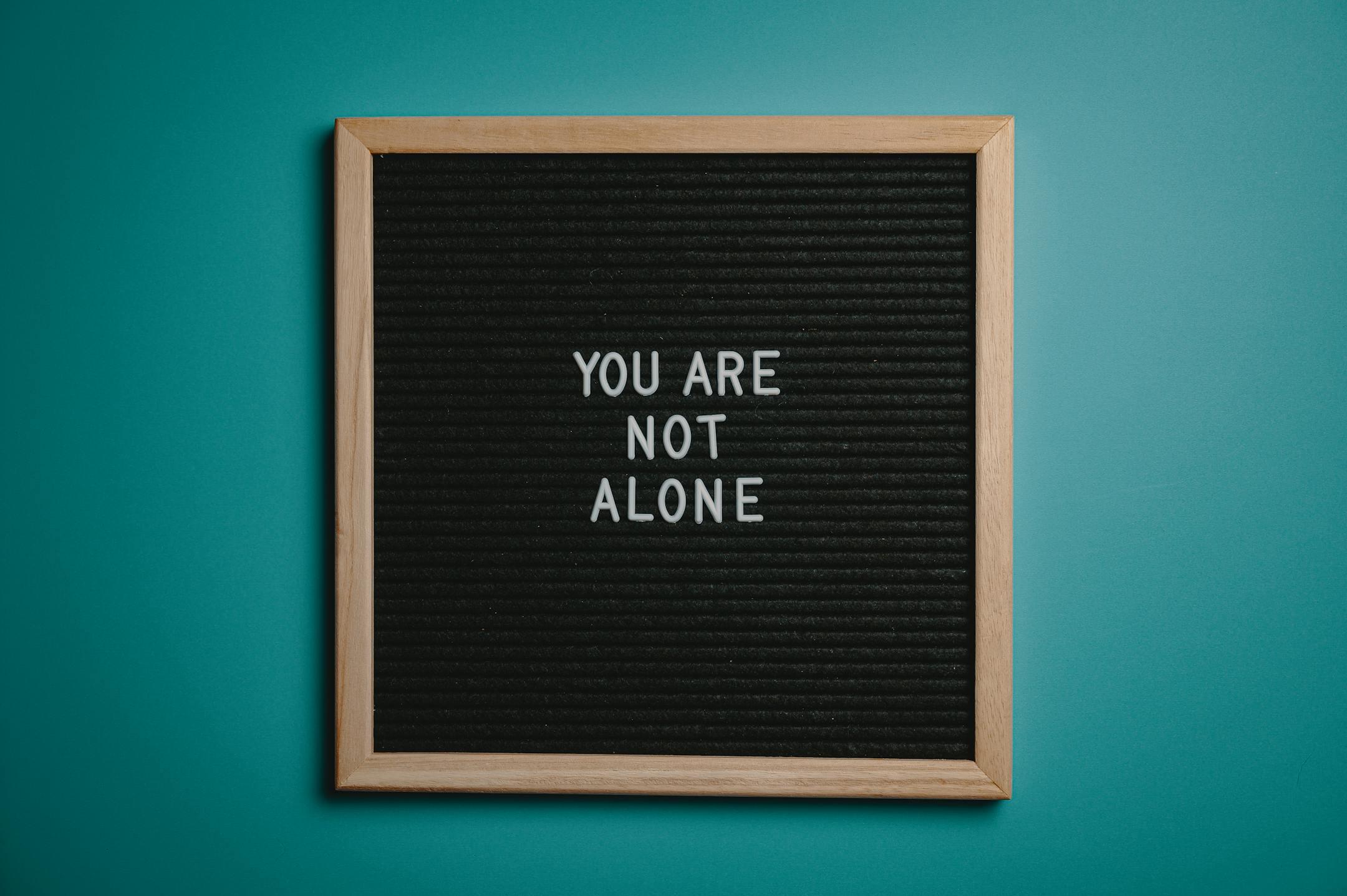 A wooden letter board displaying a motivational message on a teal background, symbolizing positivity, self-reflection, and Cognitive Analytica’s approach to improving mental health in Lebanon.