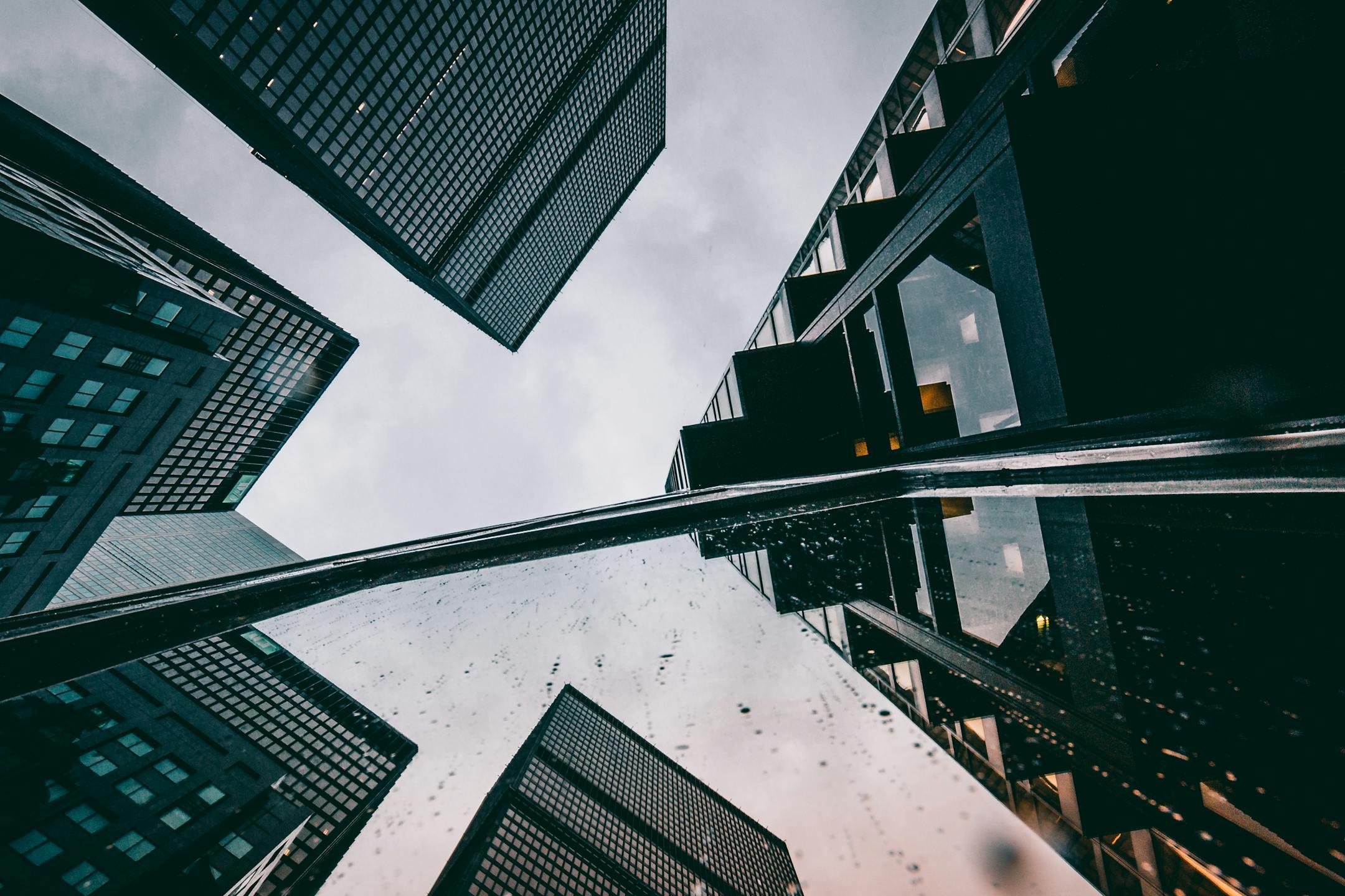 Dynamic low angle view of futuristic skyscrapers in a modern cityscape.