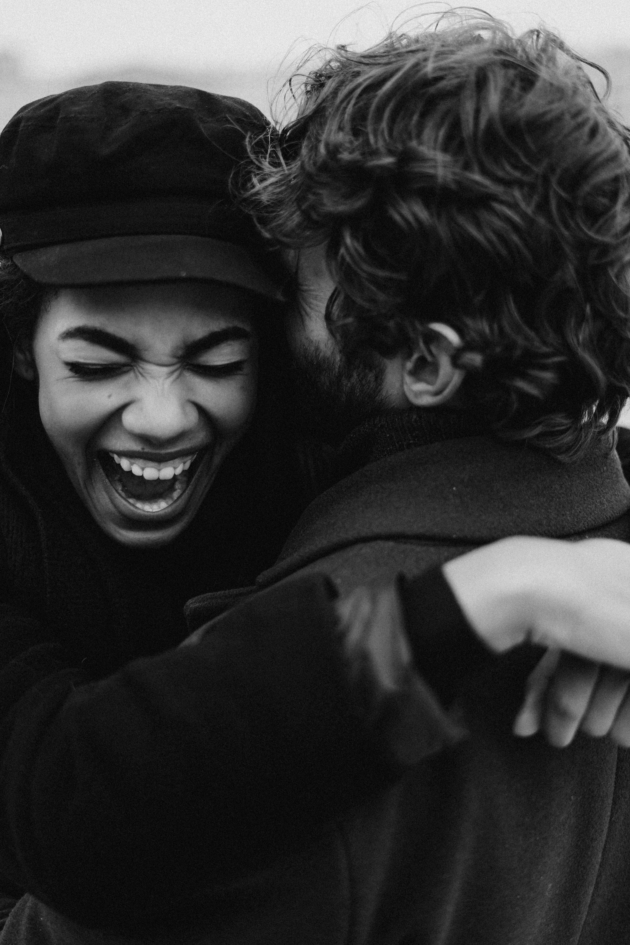 Monochrome image of a joyful couple embracing outdoors, Cognitive Analytica clients rediscovering happiness and emotional closeness after couples therapy in Lebanon