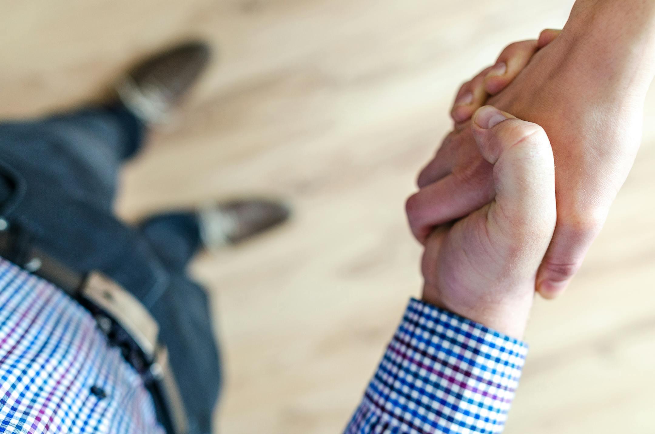 Close-up of a professional handshake inside Cognitive Analytica’s office, symbolizing trust, cooperation, and a strong therapeutic relationship with clients.