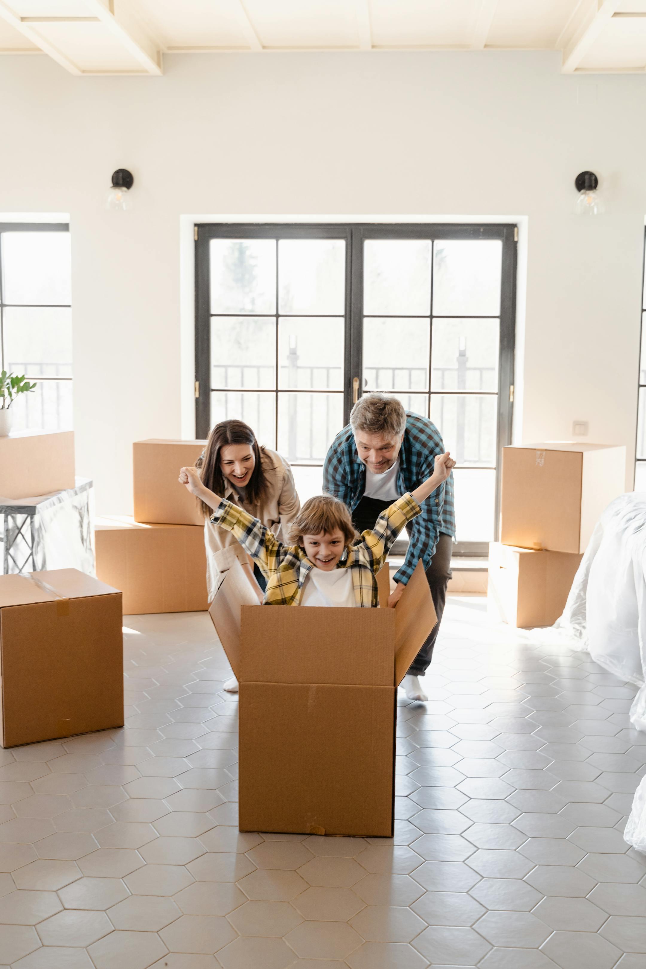 Happy Lebanese family celebrating their move into a new home with unpacked boxes—Cognitive Analytica family therapy symbolizing new beginnings, stability, and emotional growth.