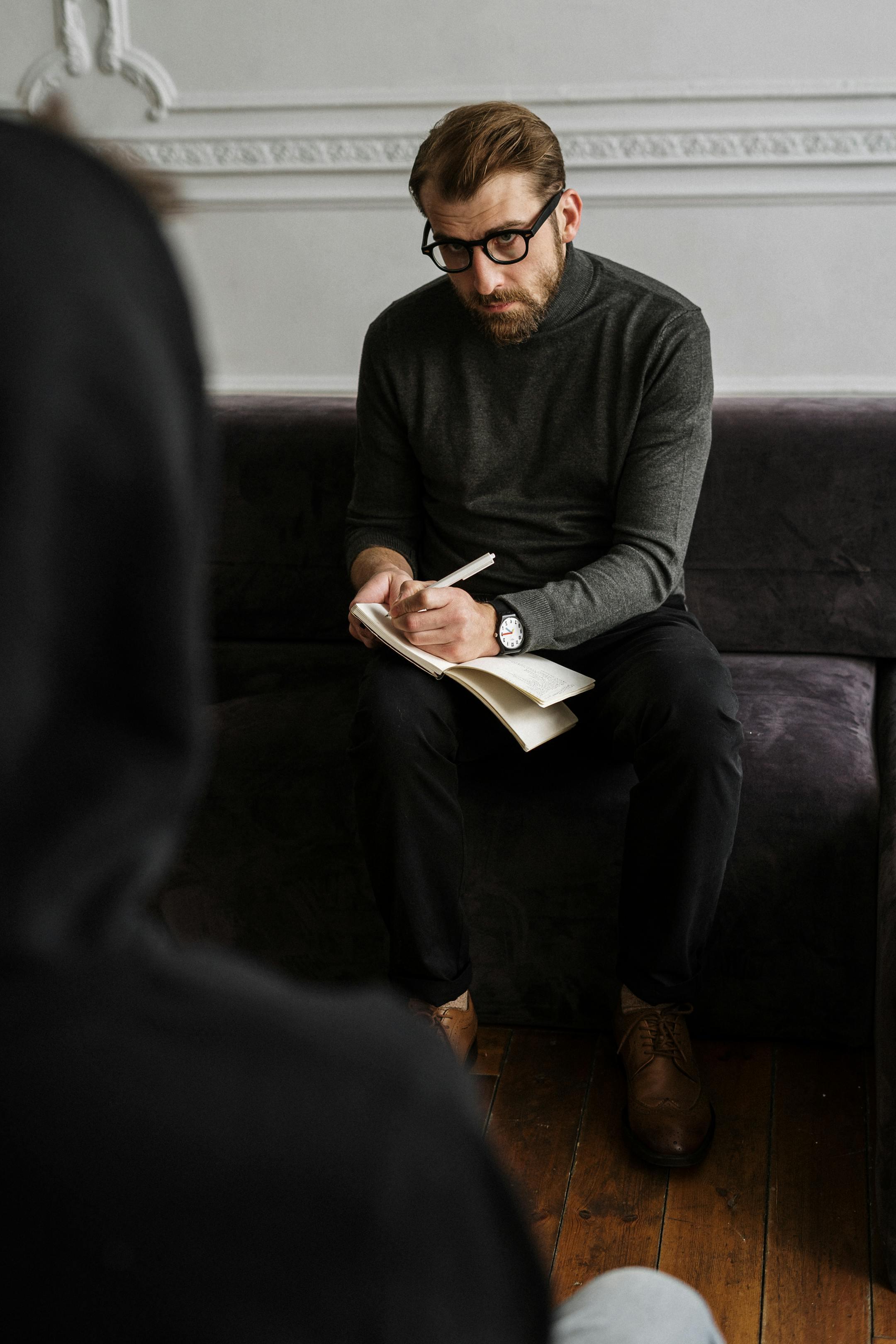 Cognitive Analytica psychologist taking notes, symbolizing licensed MoPH-registered professionals in Lebanon.