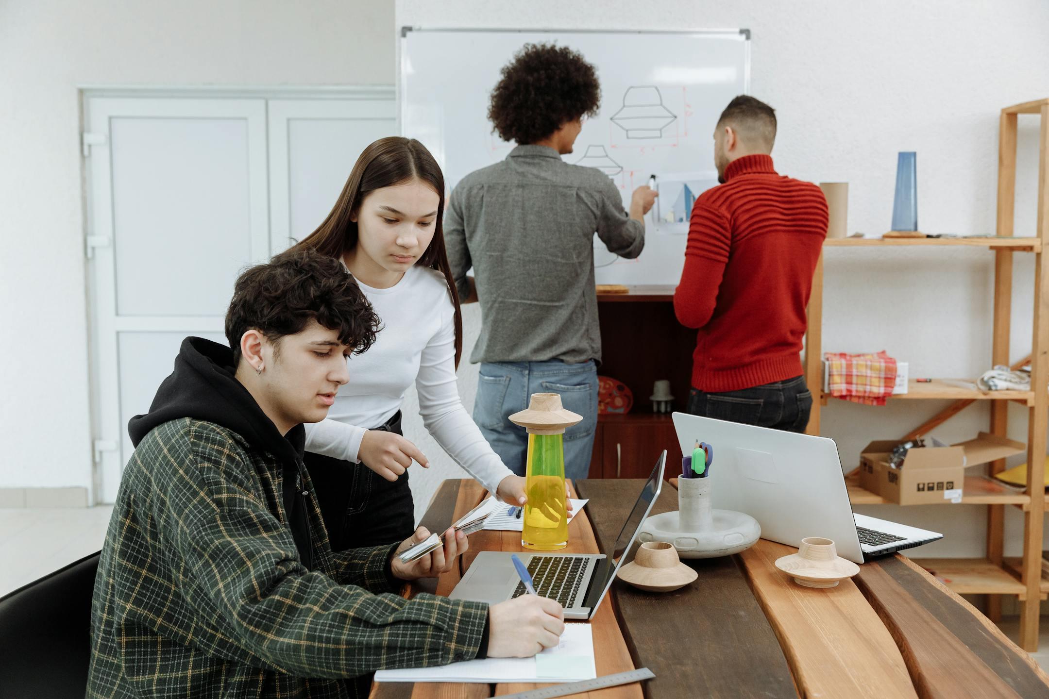 Young professionals engaged in a creative planning session in an office setting.