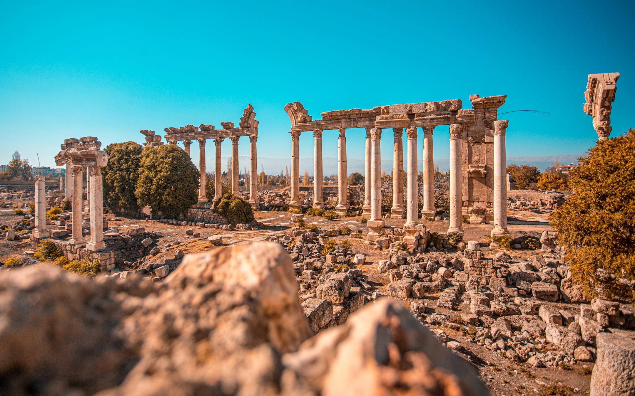 Explore the stunning ancient Roman ruins under a clear blue sky in Lebanon.